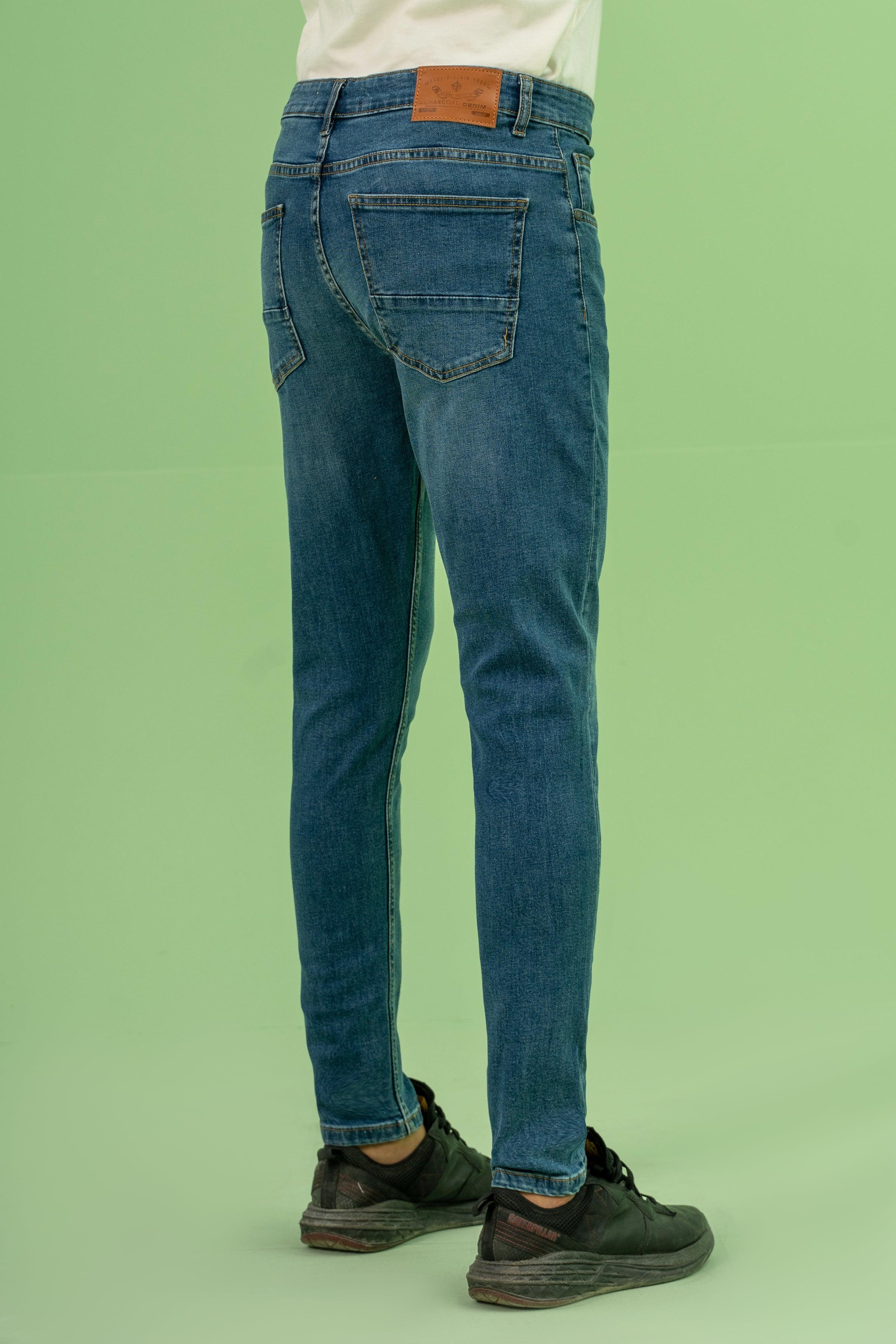 Mid-blue skinny-leg denim jeans with leather patch at waistband and back pockets