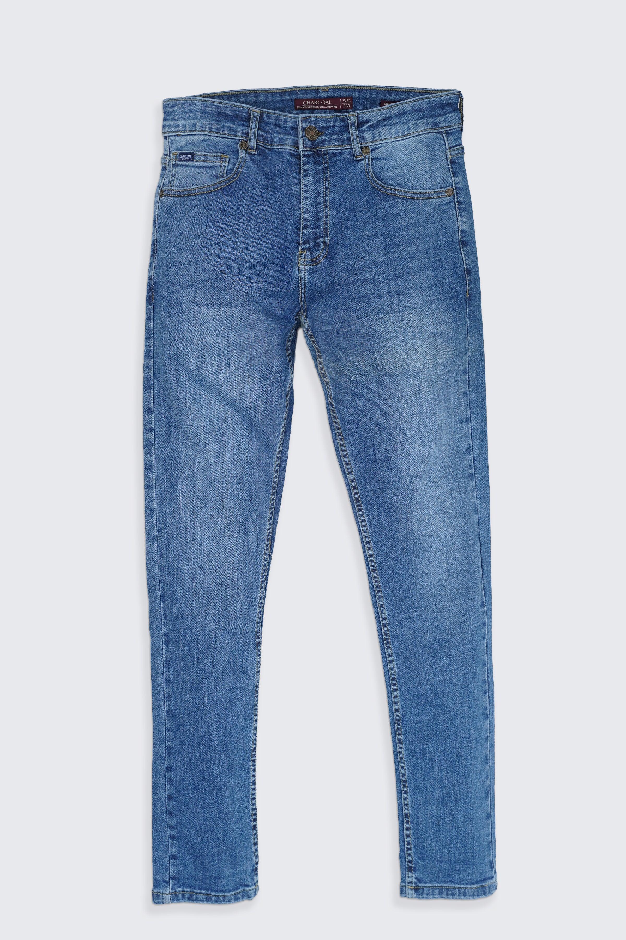 Mid-blue skinny jeans with five-pocket design, zip fly and belt loops