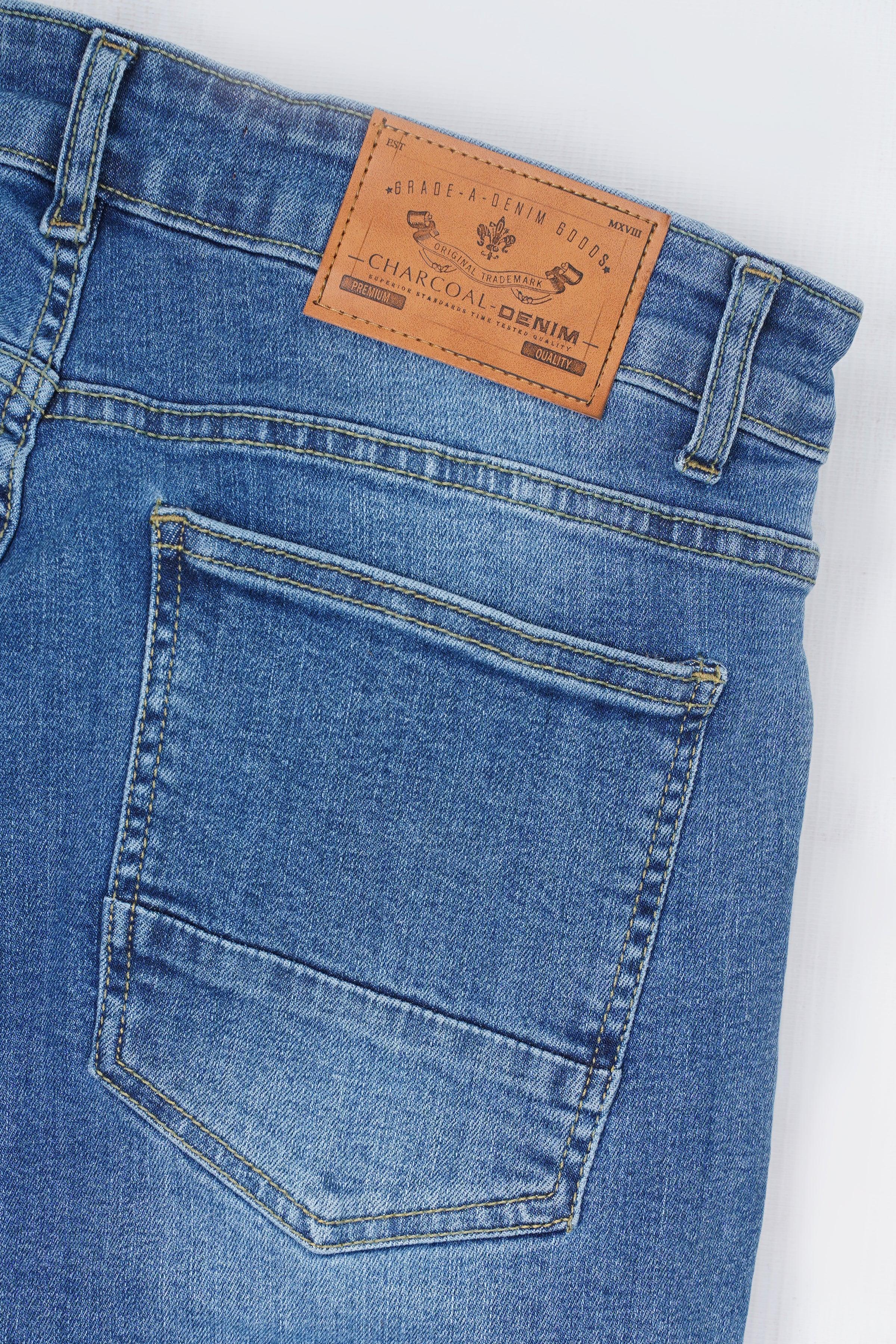 Mid-blue skinny jeans back pocket with leather brand patch