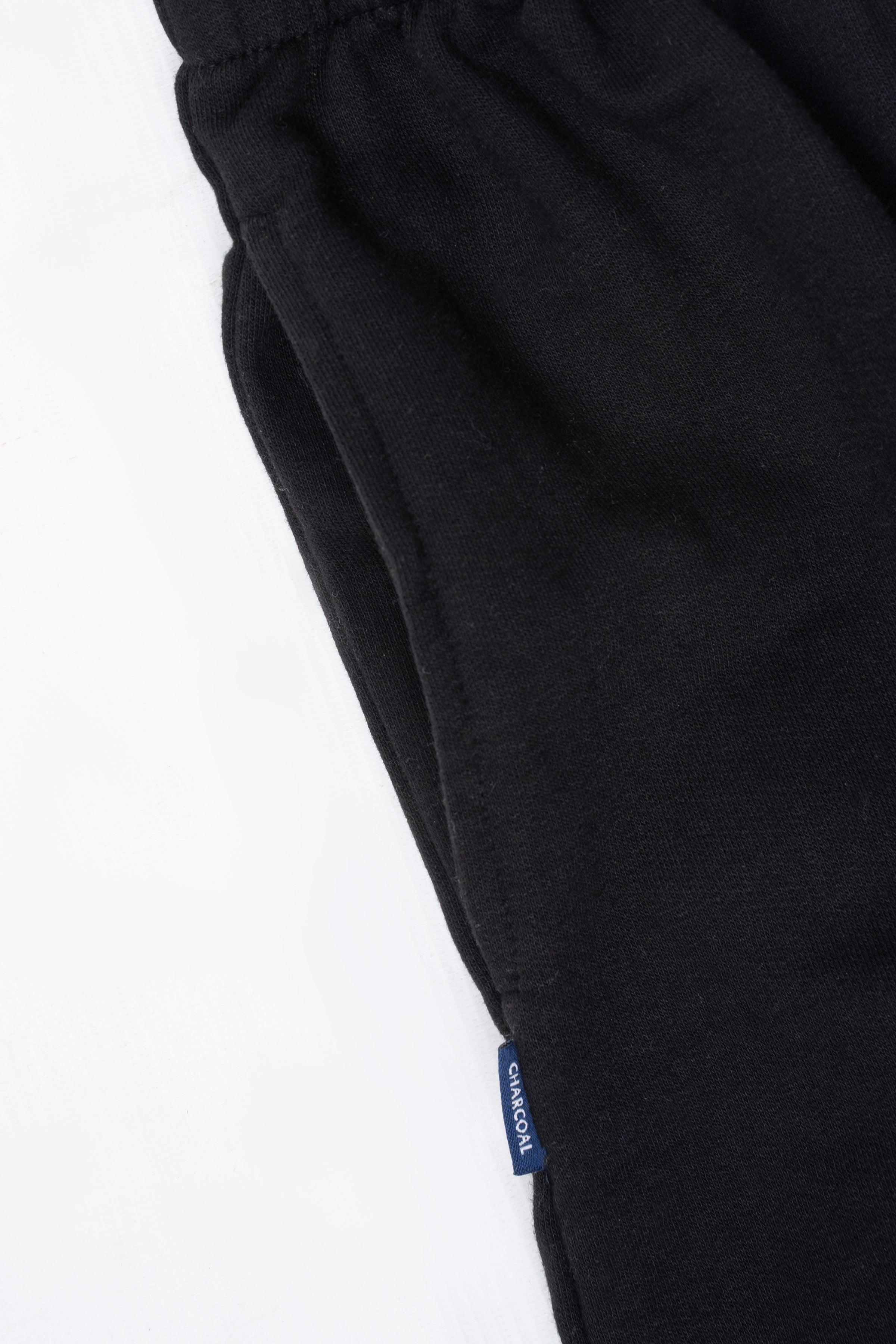 Black sleepwear trouser side label near hem, tapered leg