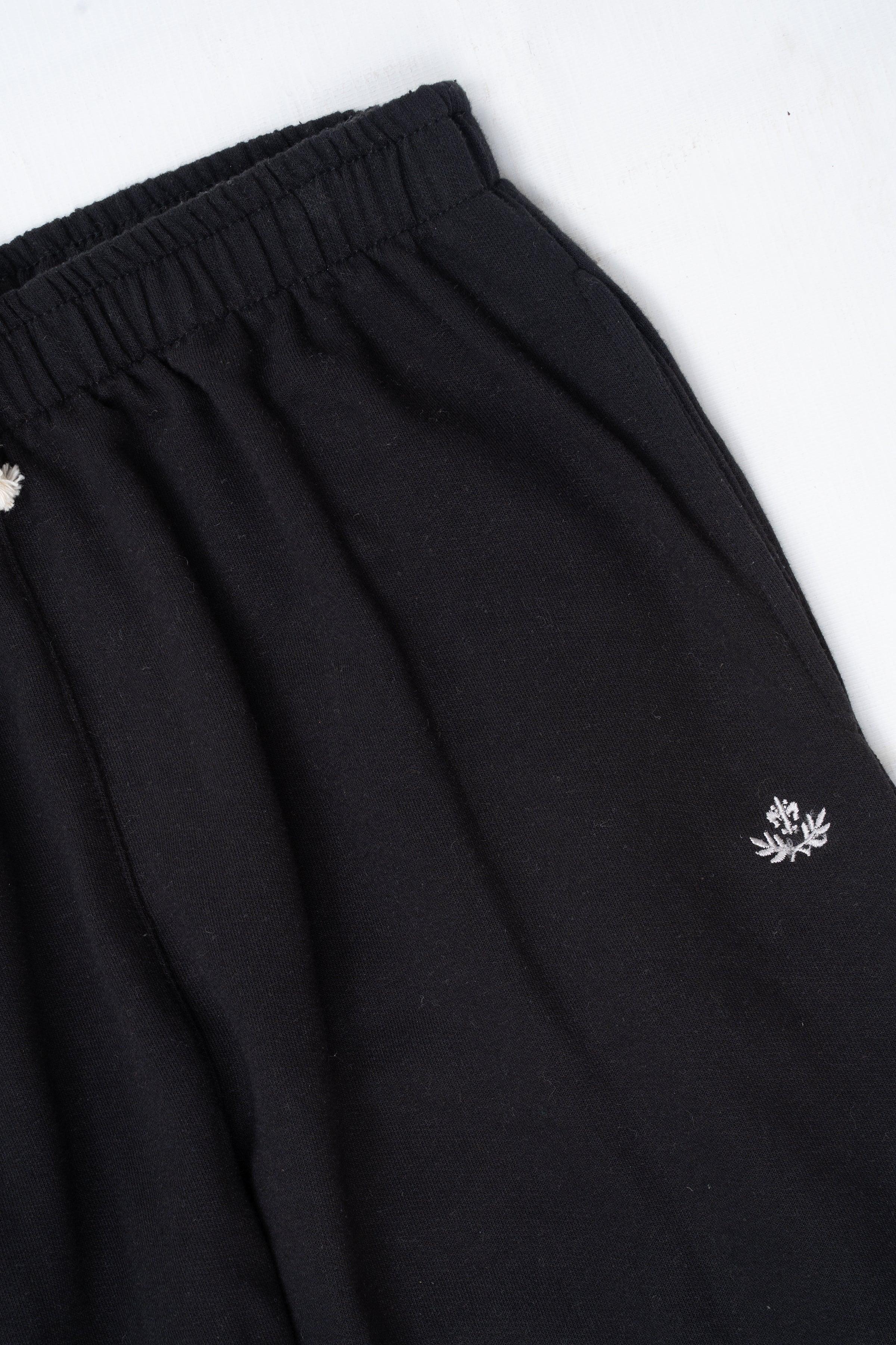 Black sleepwear trouser close-up of gathered waist and side snowflake logo