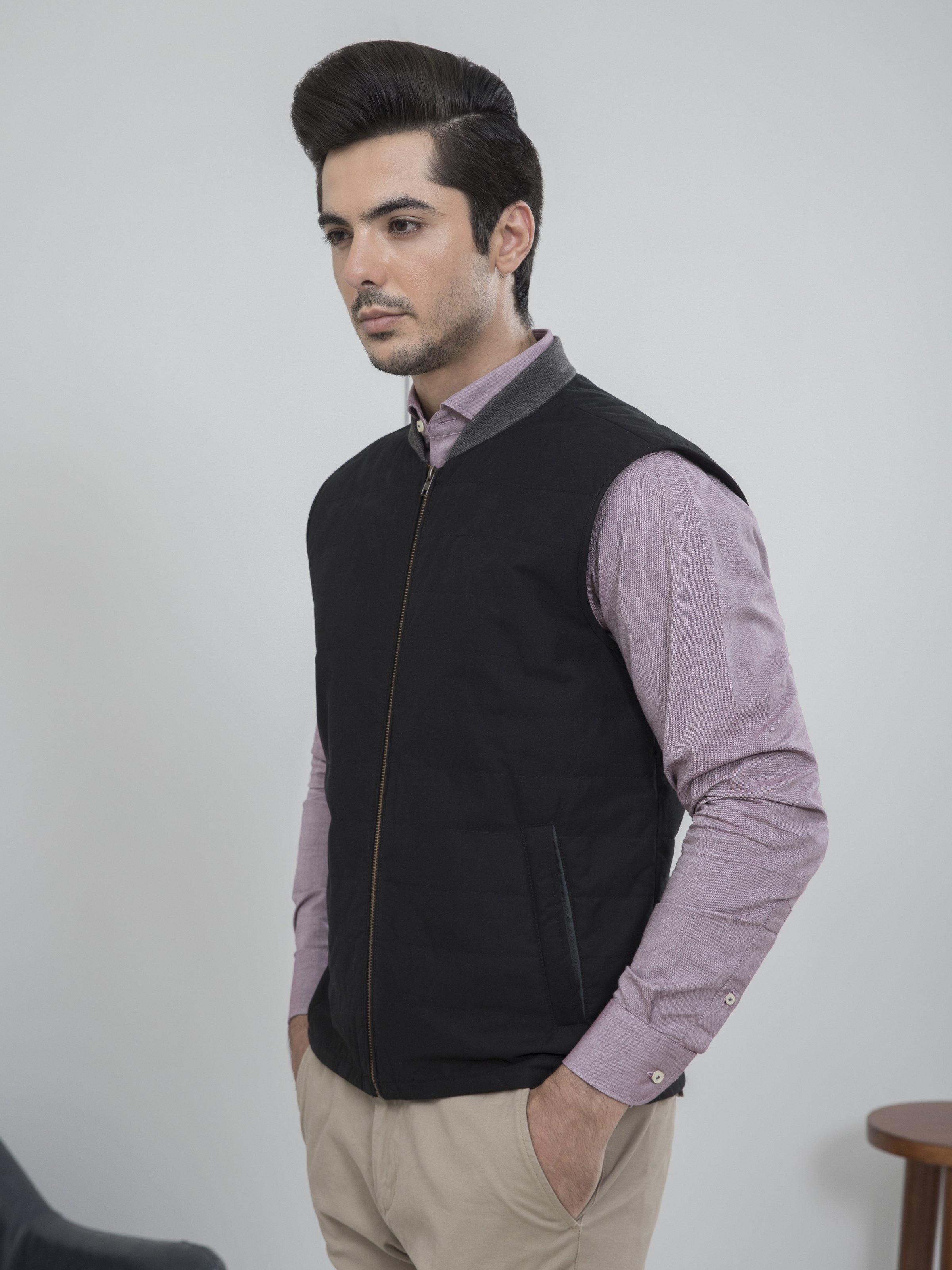 Sleeveless quilted jacket with zip front, stand collar, and dark quilted body
