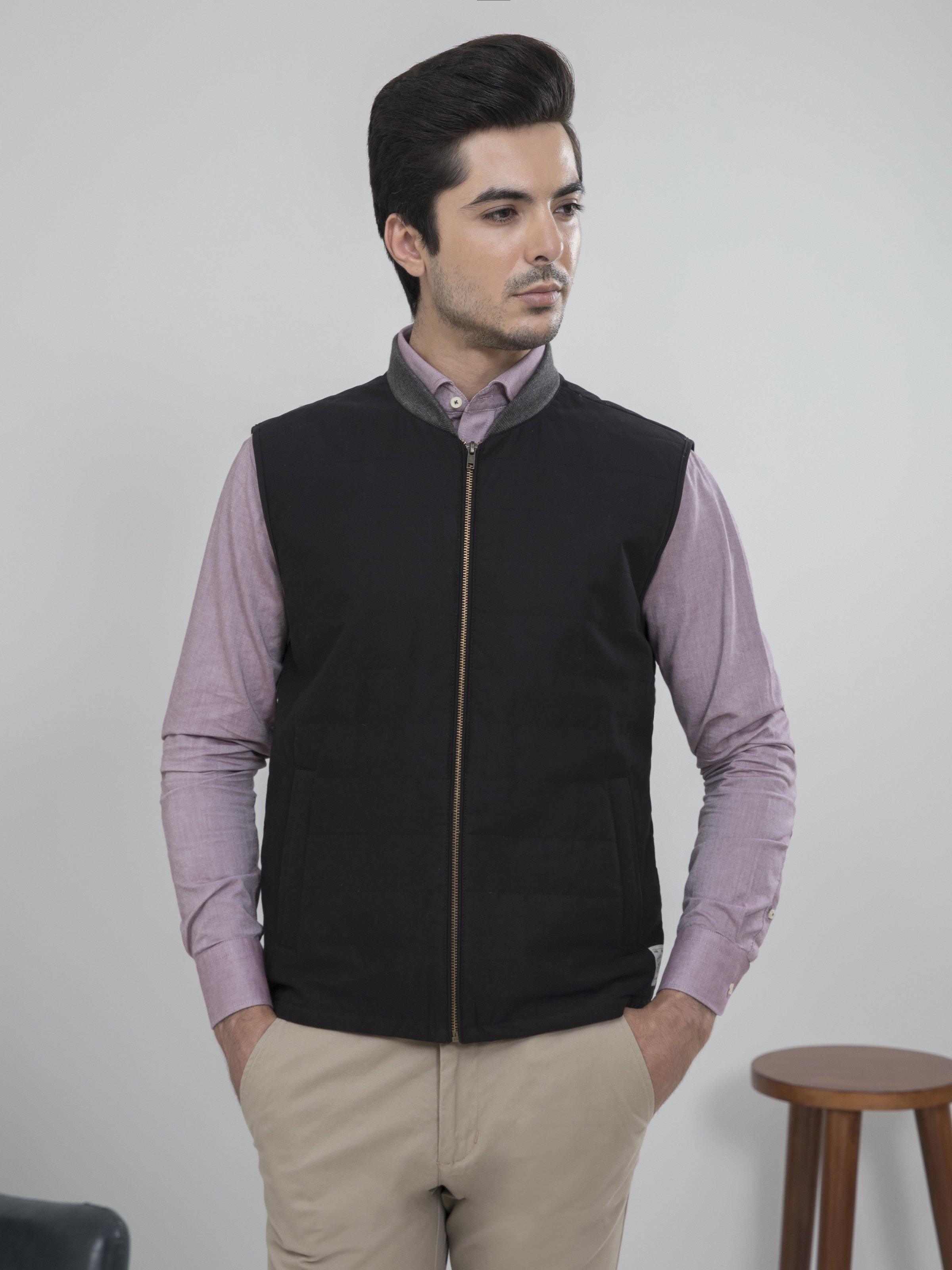 Sleeveless quilted jacket with zip front, stand collar, and dark side pockets