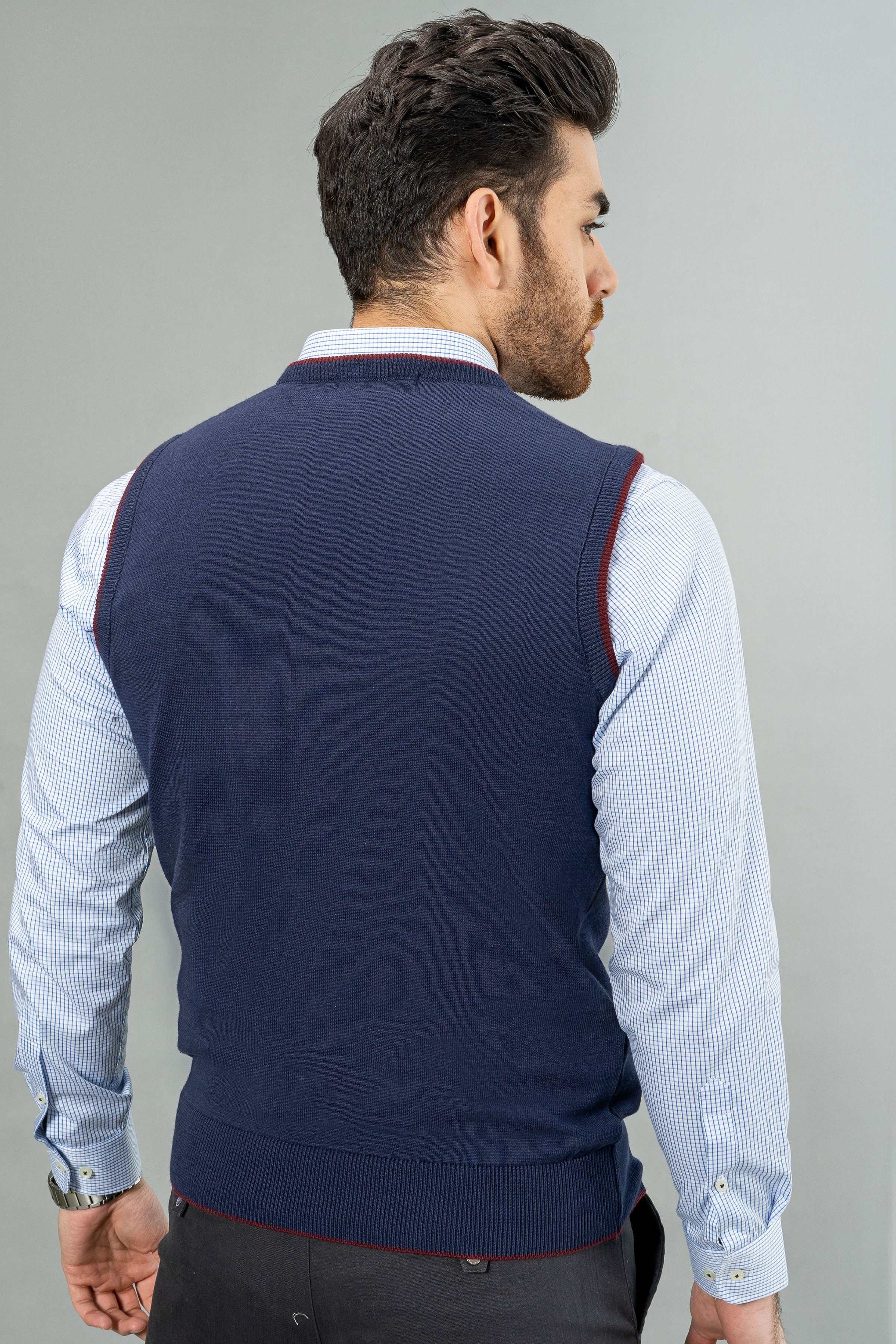 Back view of navy sleeveless sweater vest with ribbed neckline and hem