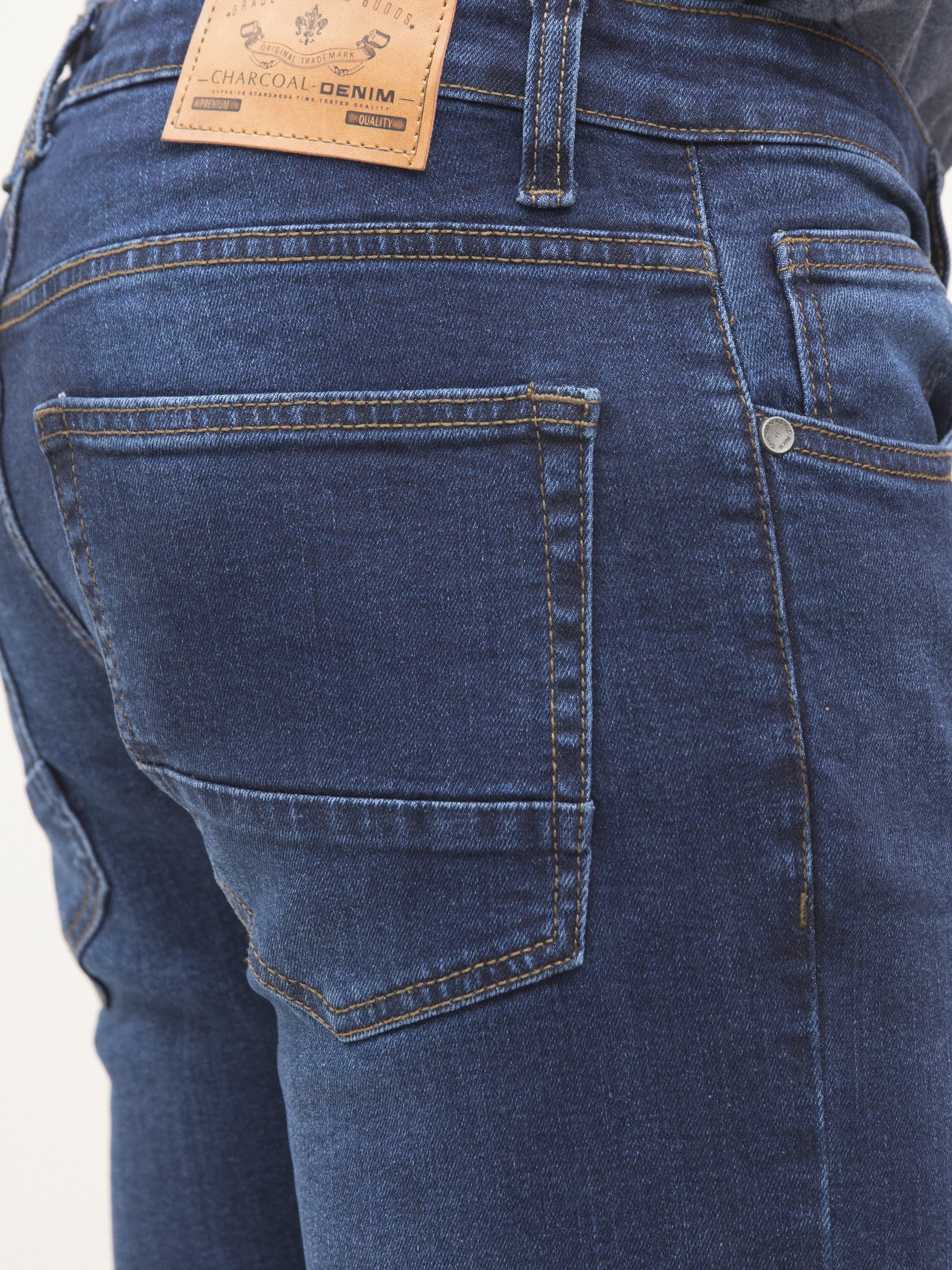 Dark blue jeans close-up, front coin pocket and stitched side pocket