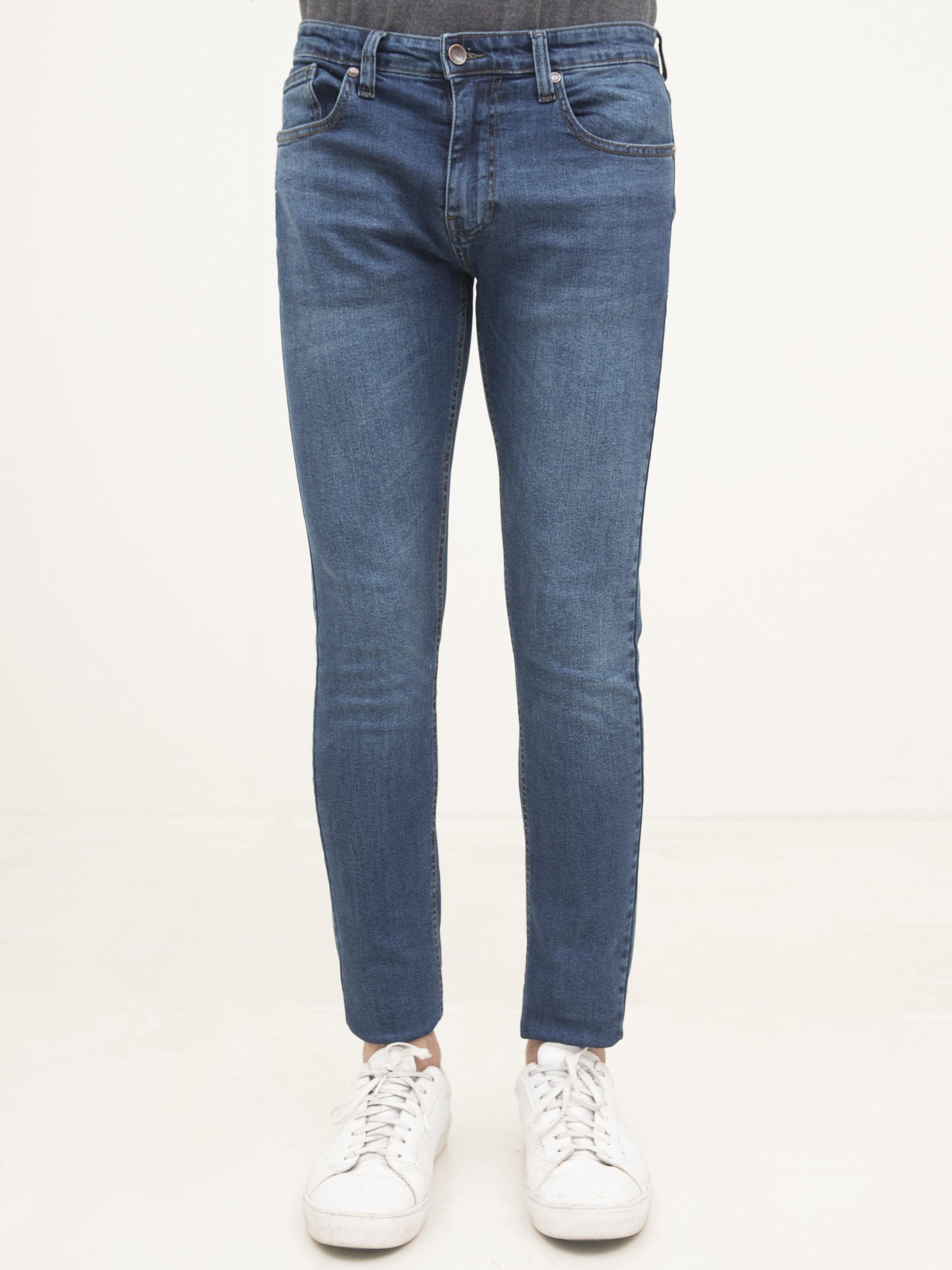 Slim-fit mid-blue jeans, front view with zip fly, belt loops and stitched pockets