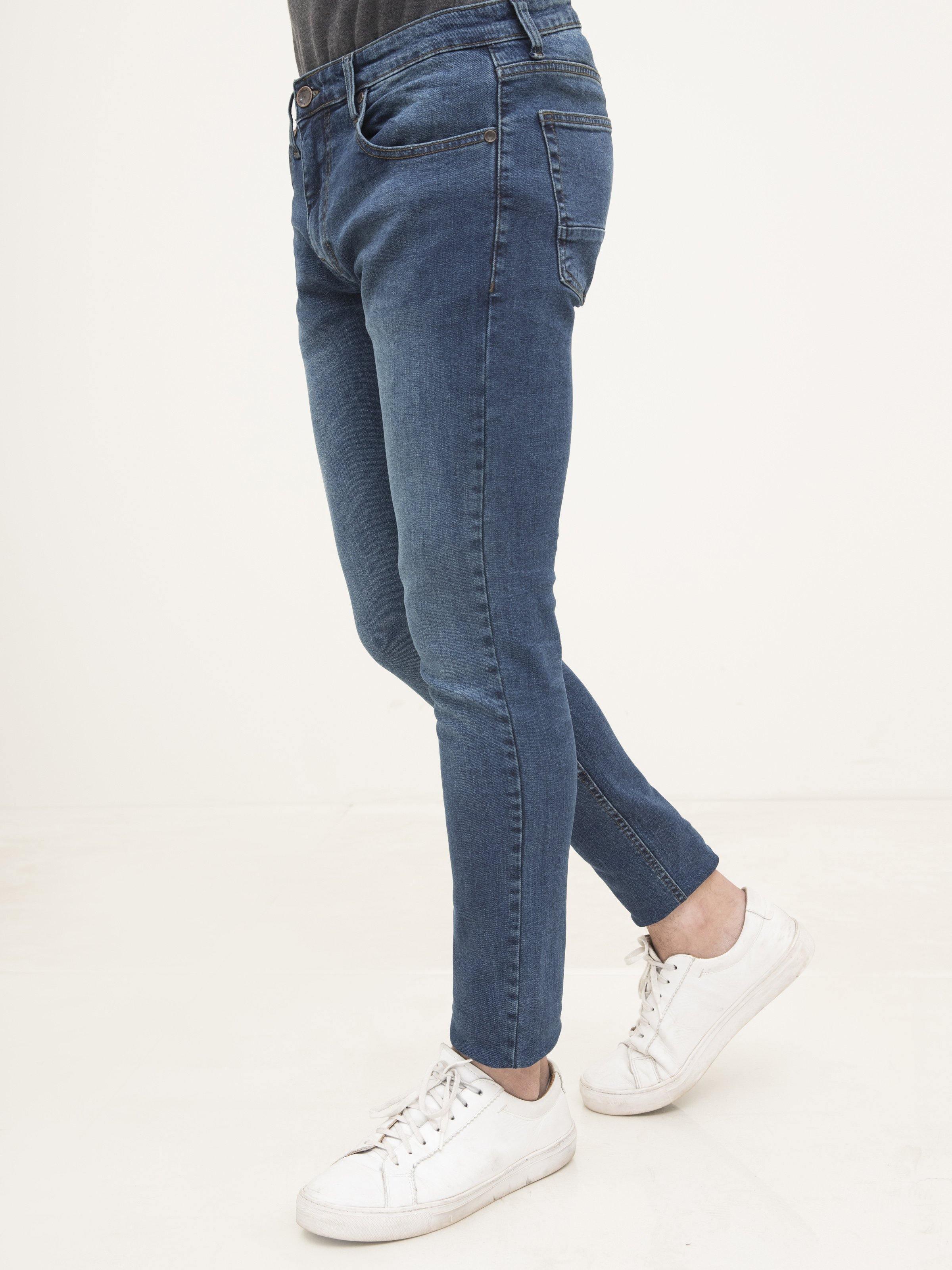Slim-fit mid-blue jeans with button fly, five-pocket design and belt loops