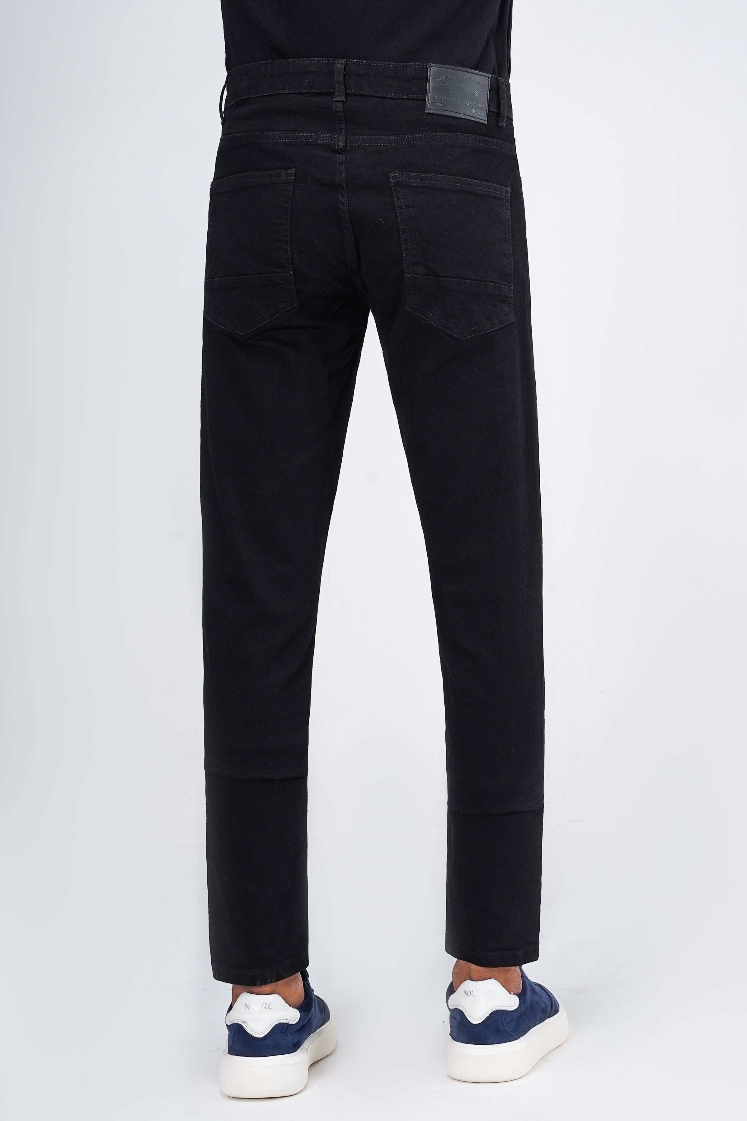 Black slim-leg jeans back view with stitched yoke and two rear patch pockets