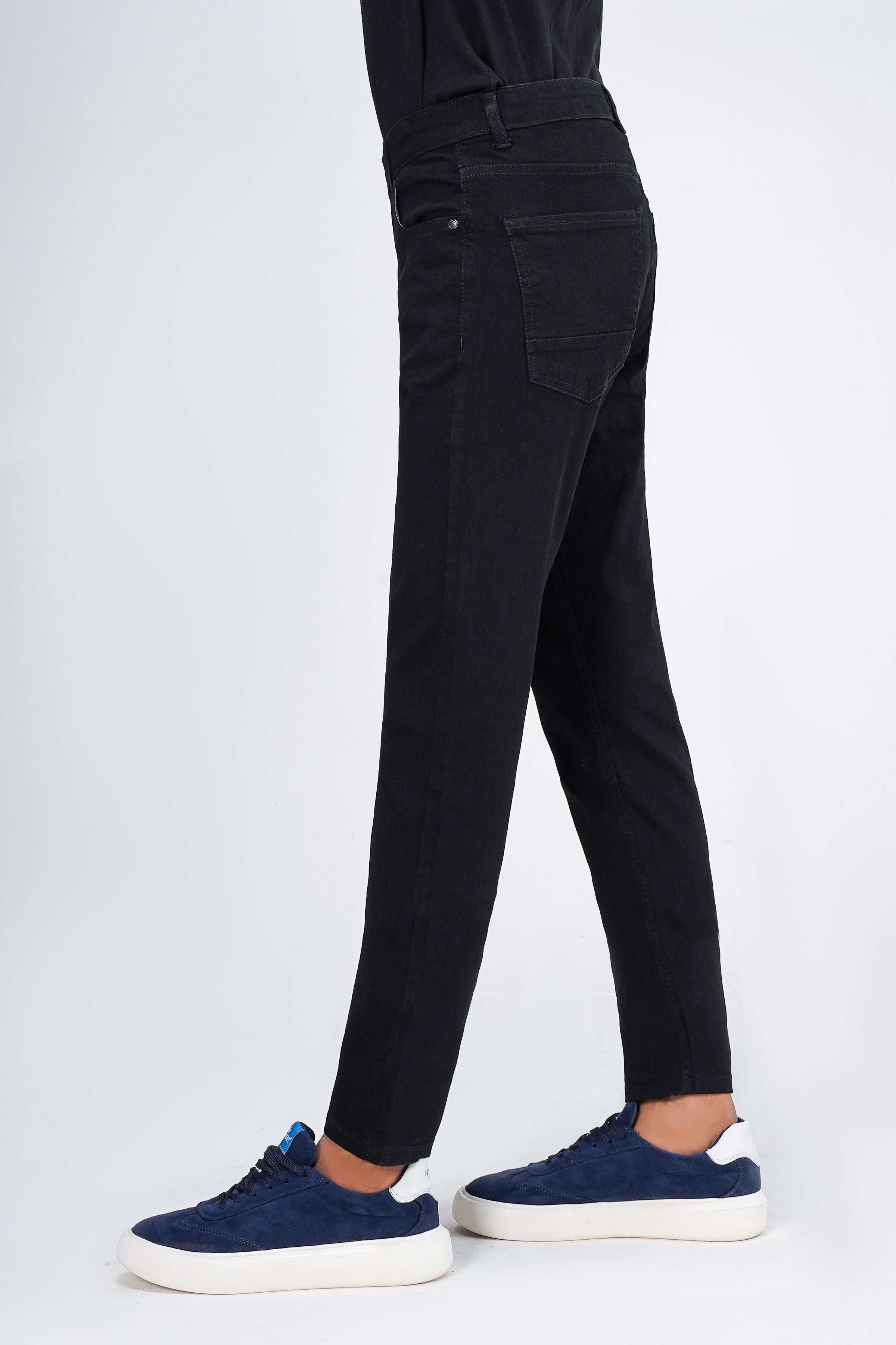 Black slim-leg jeans with button fly, belt loops, and tapered straight legs