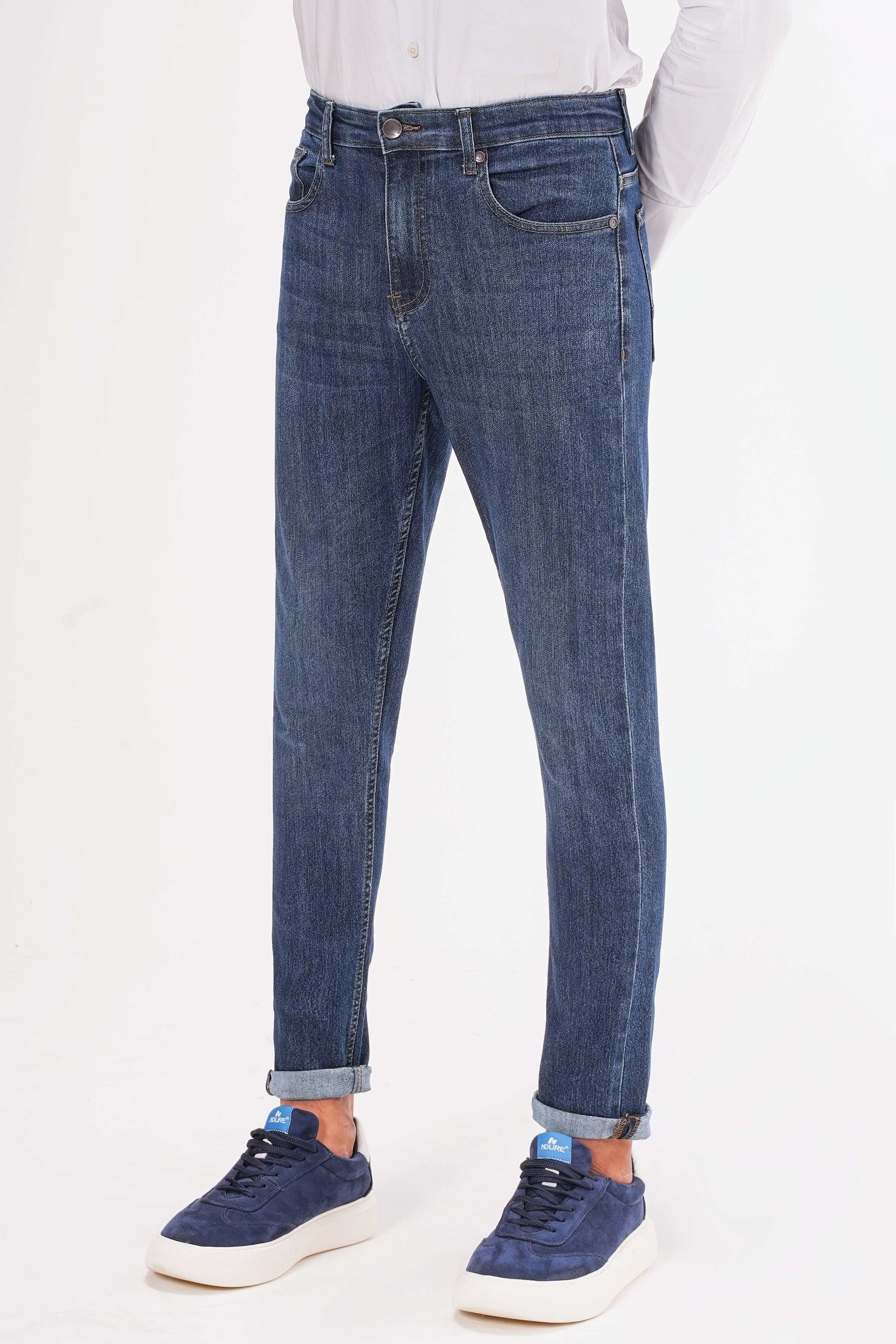 Dark blue slim-leg jeans front view, five-pocket style, belt loops, ankle-length hem