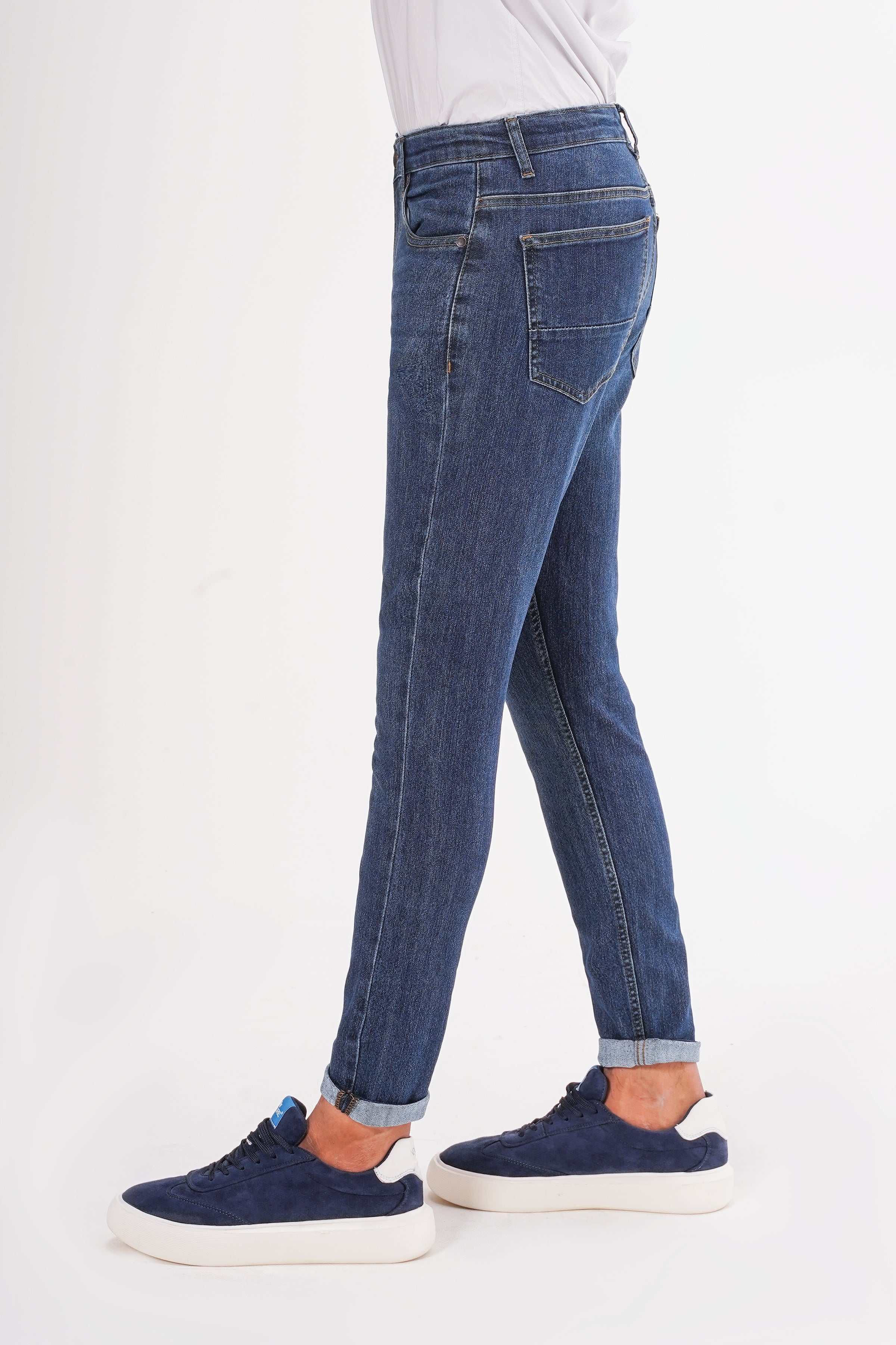 Dark blue slim-leg jeans with five pockets, belt loops, button-and-zip fly, cuffed hem