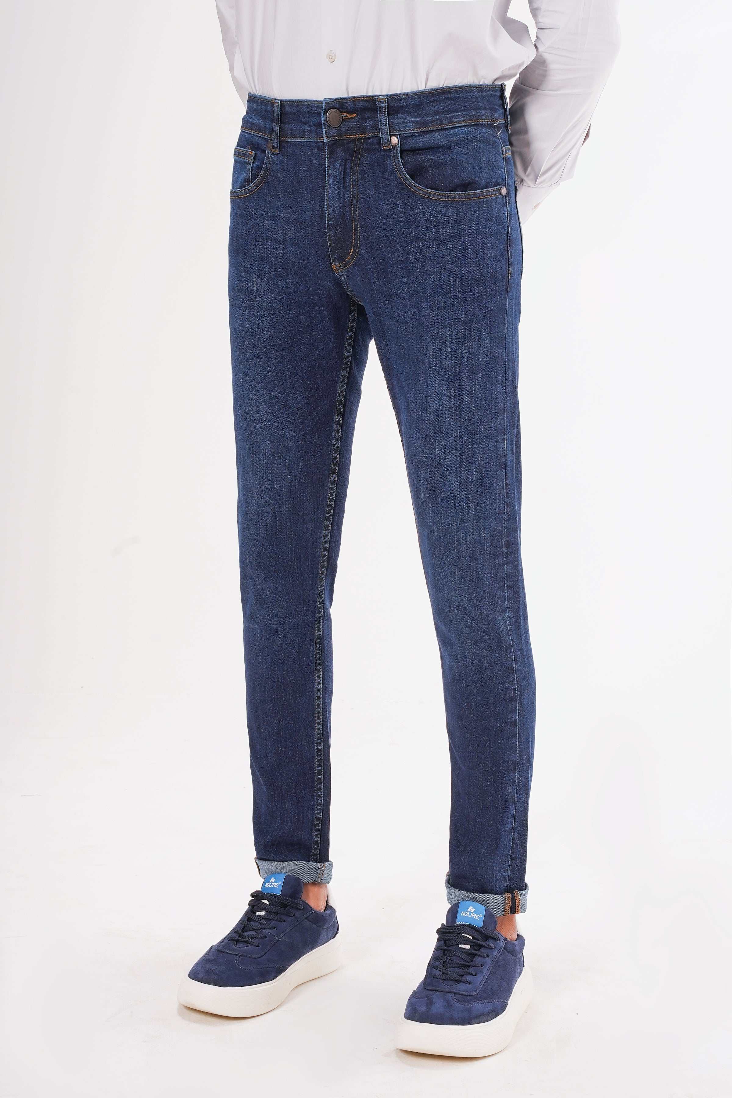 Dark blue slim-leg jeans with five-pocket design, belt loops, and zip fly