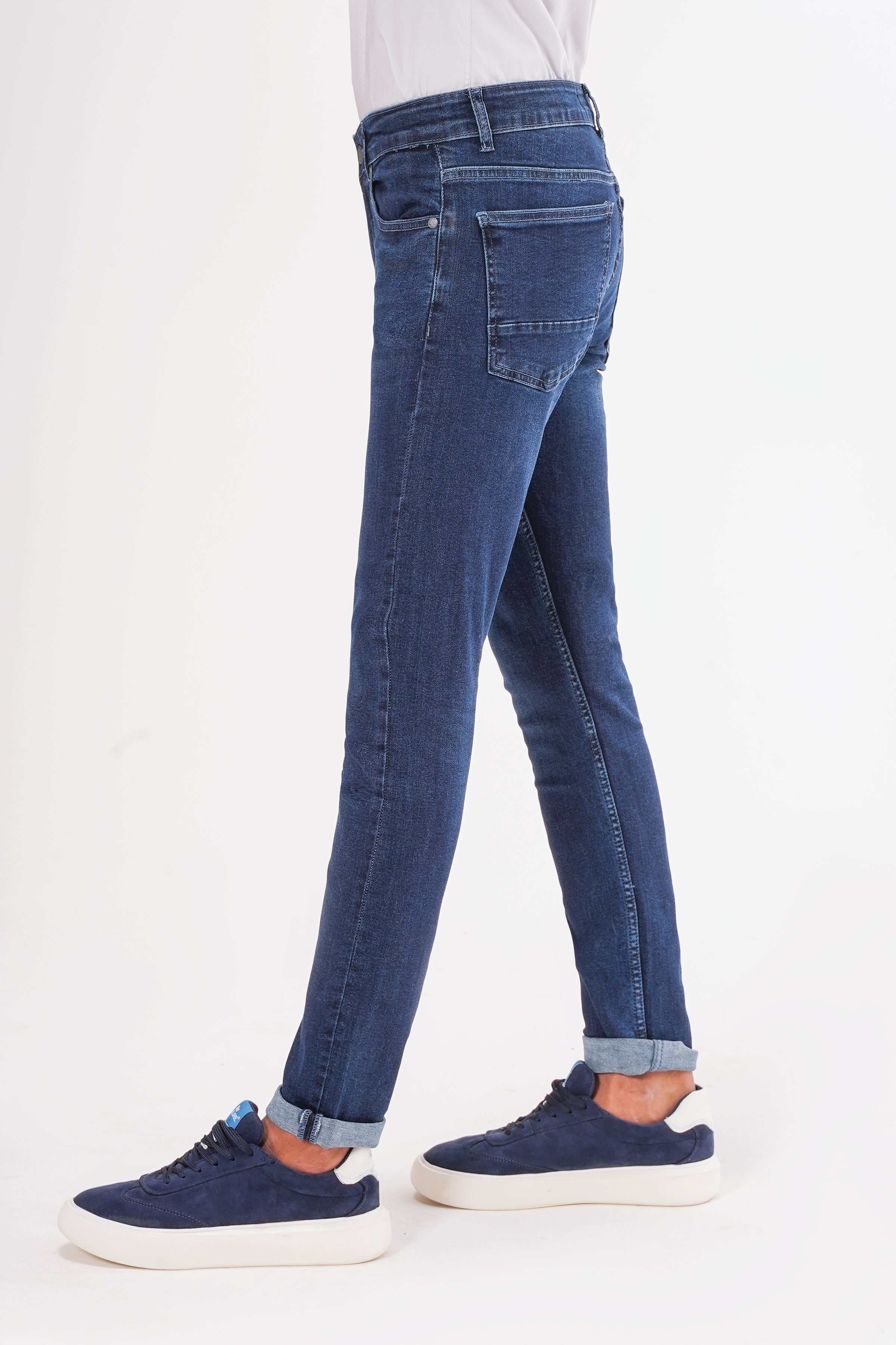 Dark navy slim-fit jeans, side view with slim straight legs.
