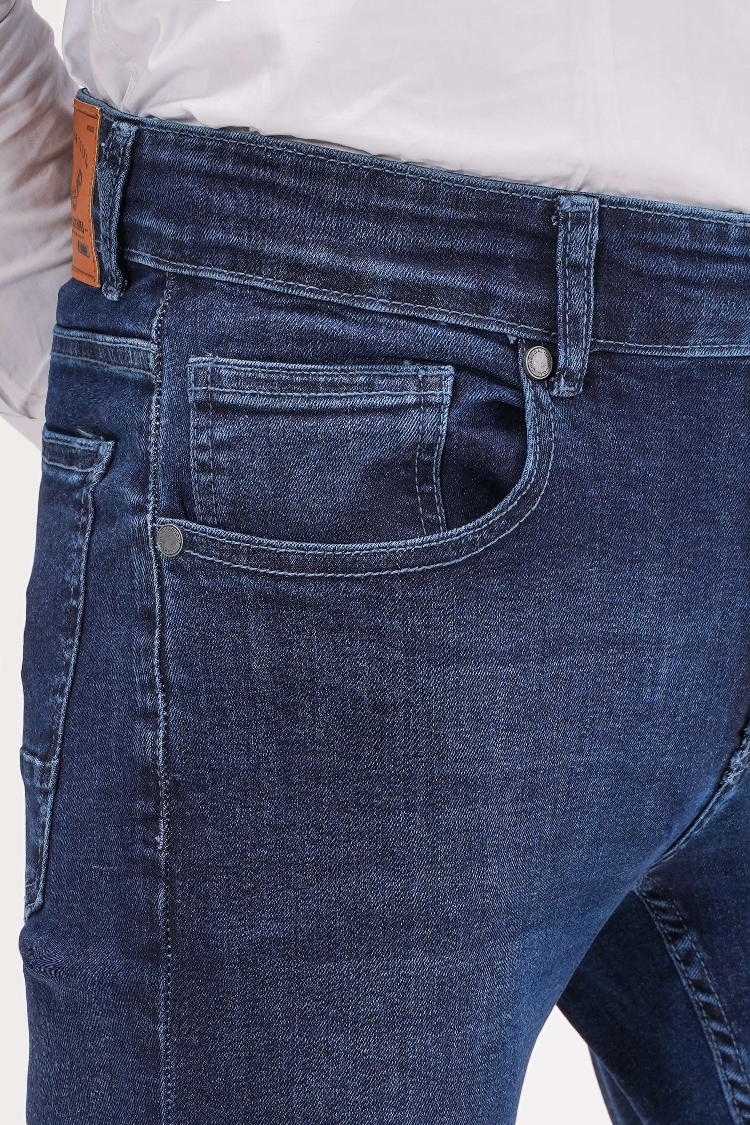 Dark navy denim jeans close-up: front pocket, waistband button, belt loops.