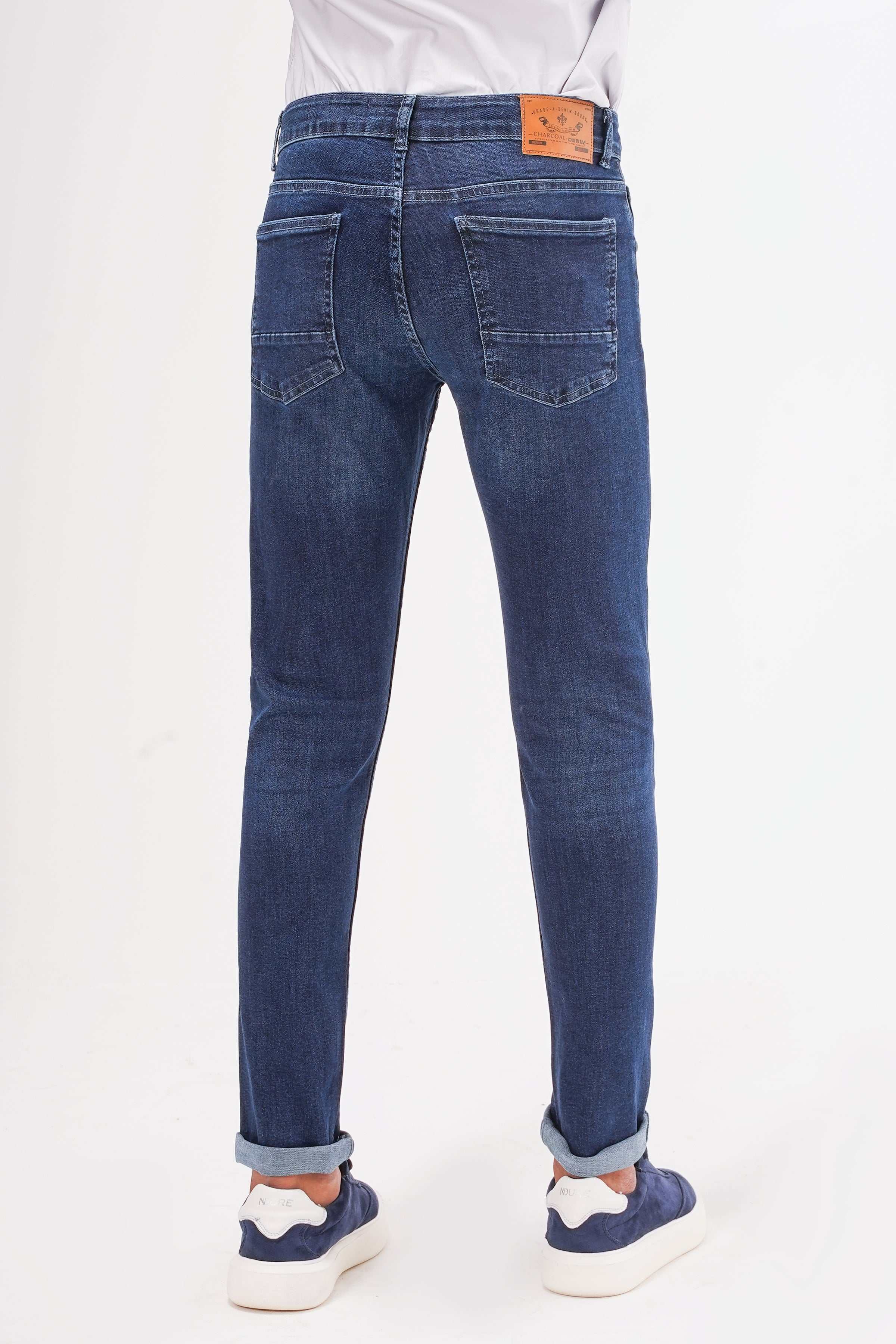 Dark navy slim-fit jeans, back view with belt loops and back pockets.
