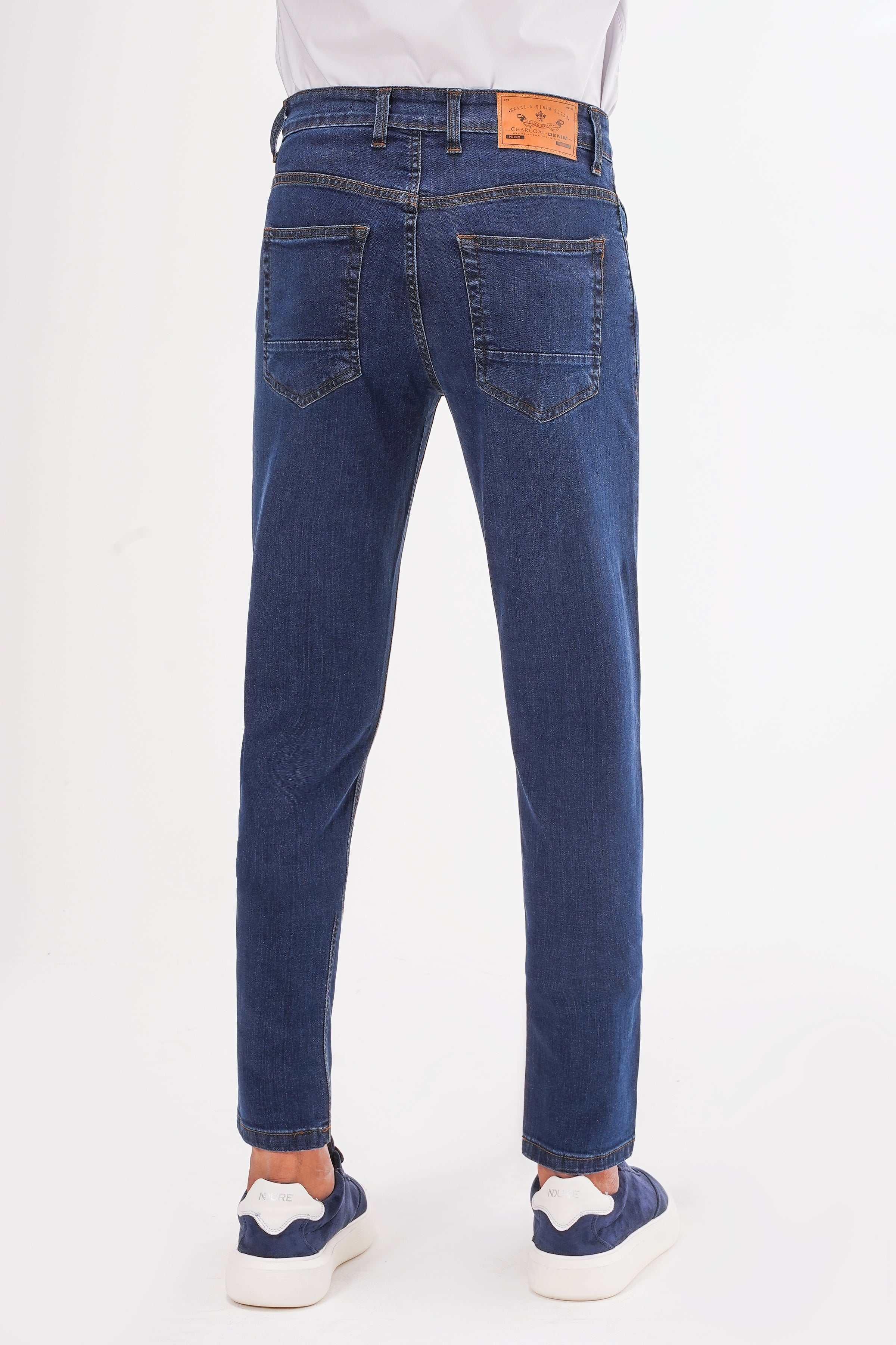 Mid-blue slim leg jeans, back view, straight slim fit with stitched back yoke.