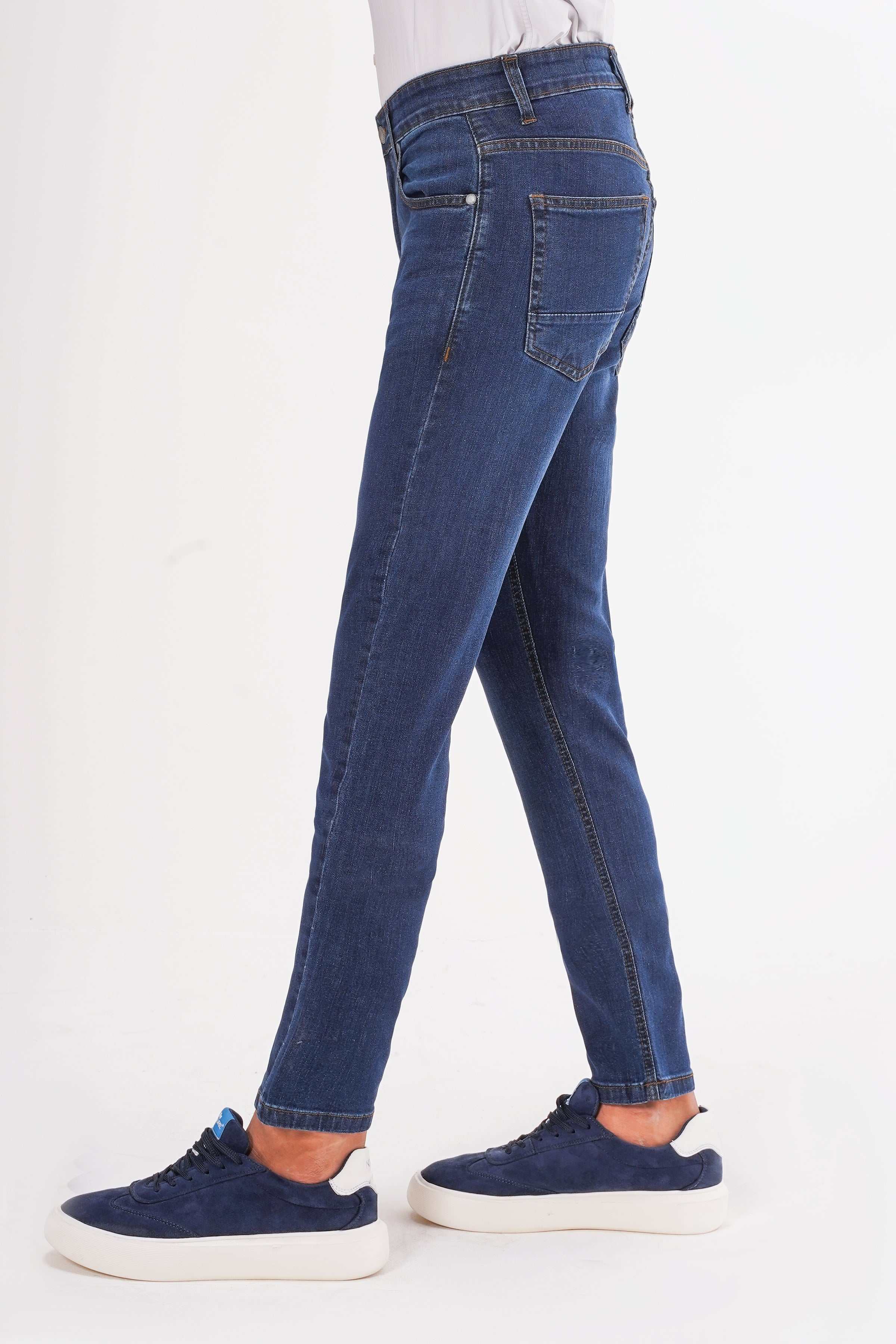 Mid-blue slim leg jeans with belt loops, zip fly, and five-pocket design.
