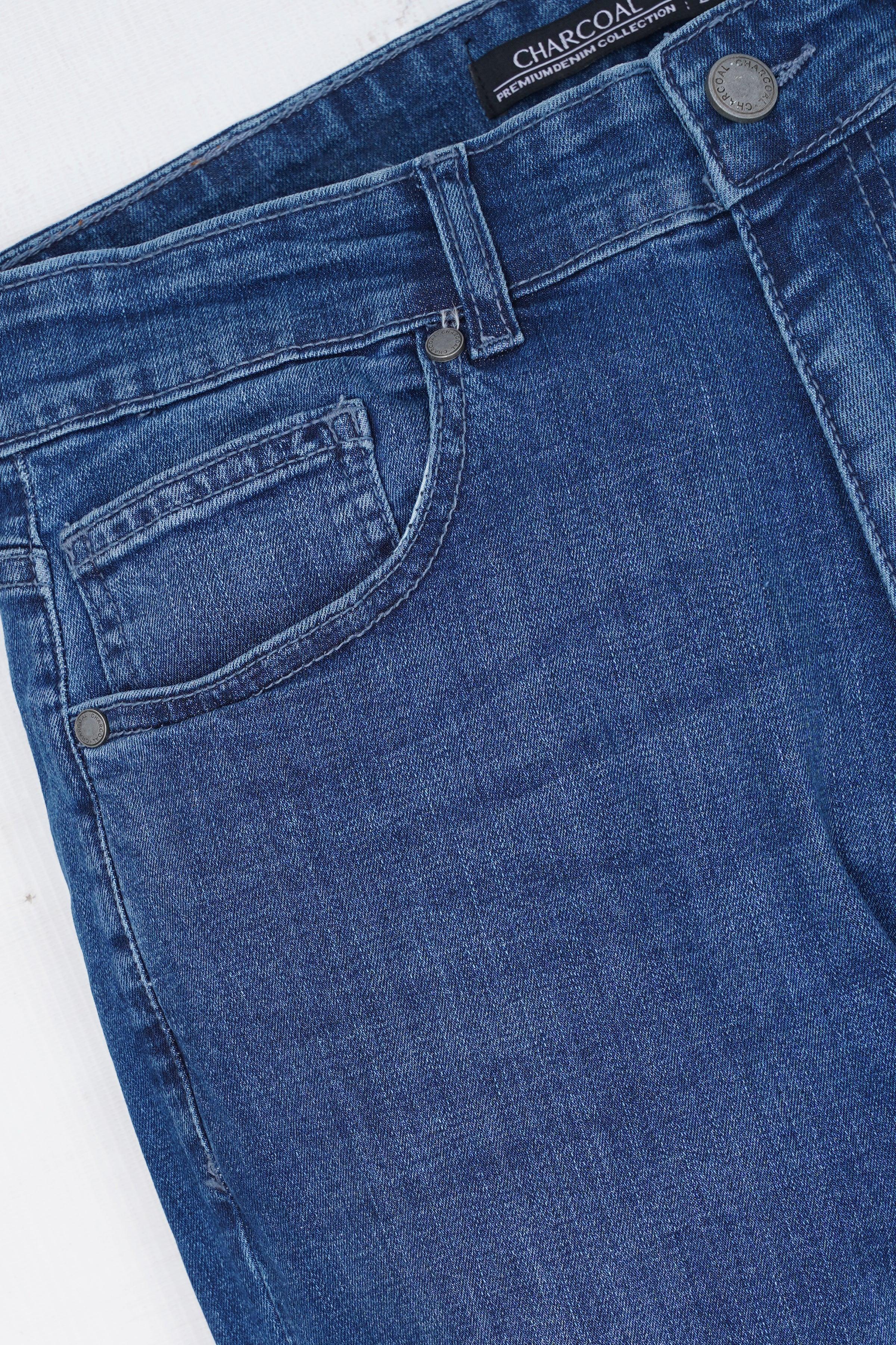 Light blue slim-leg jeans close-up of front pockets and waistband