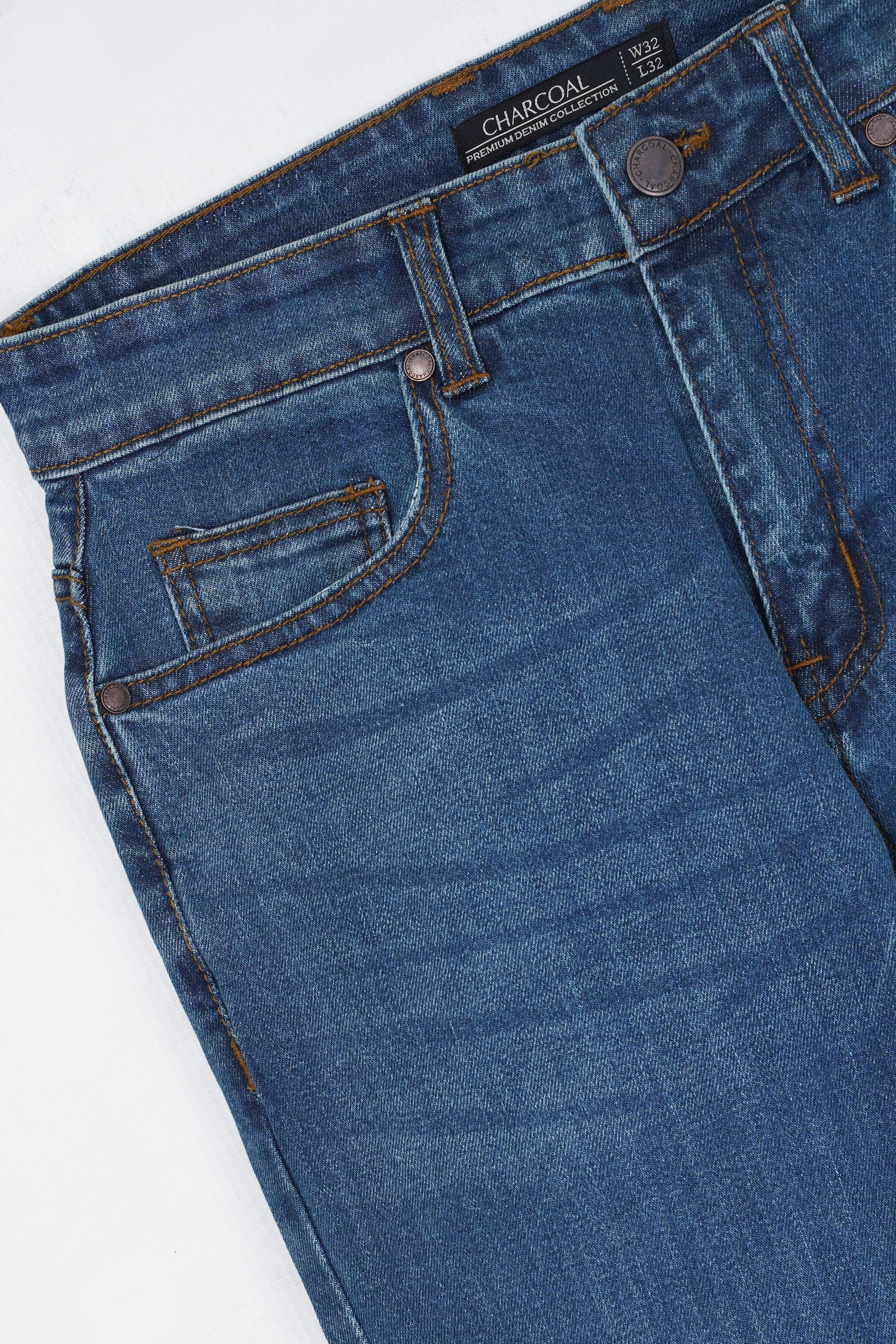 Mid-blue jeans front close-up with belt loops and button closure