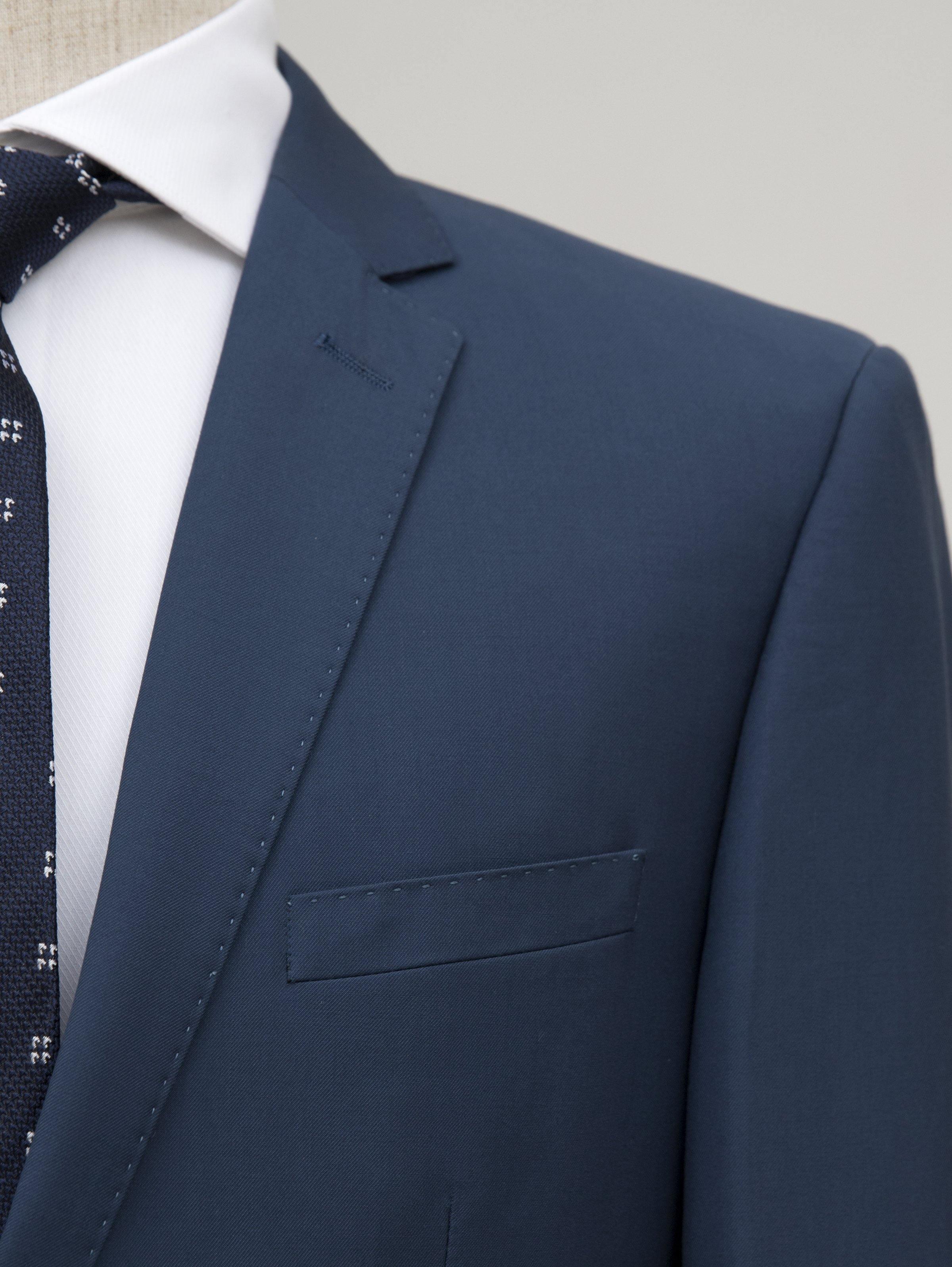 Blue suit jacket lapel and chest pocket, close-up