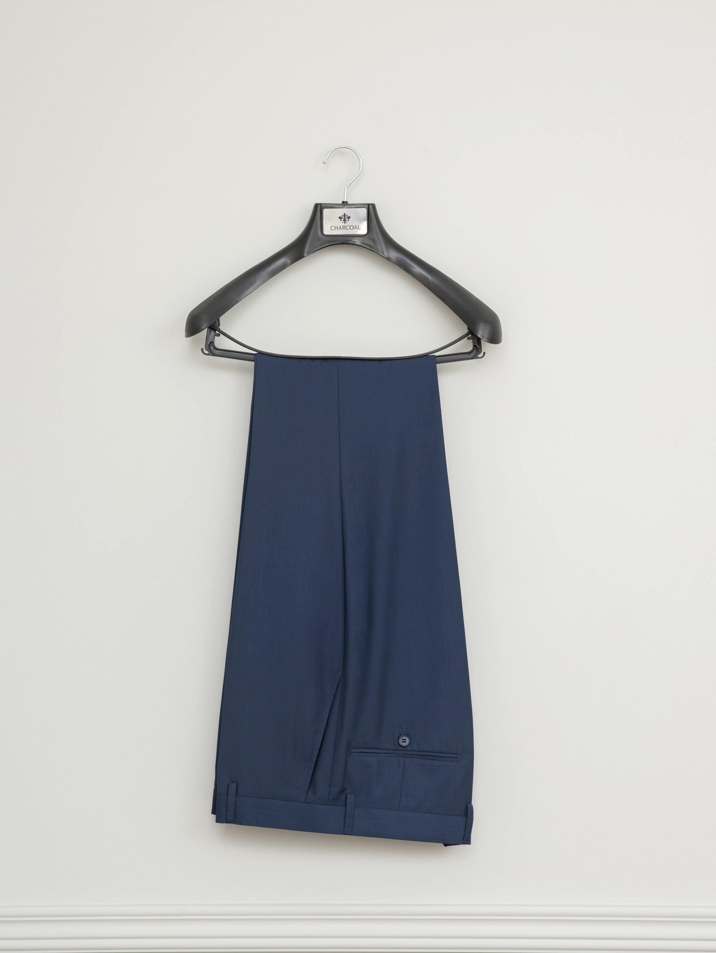 Blue suit trousers with belt loops on a hanger