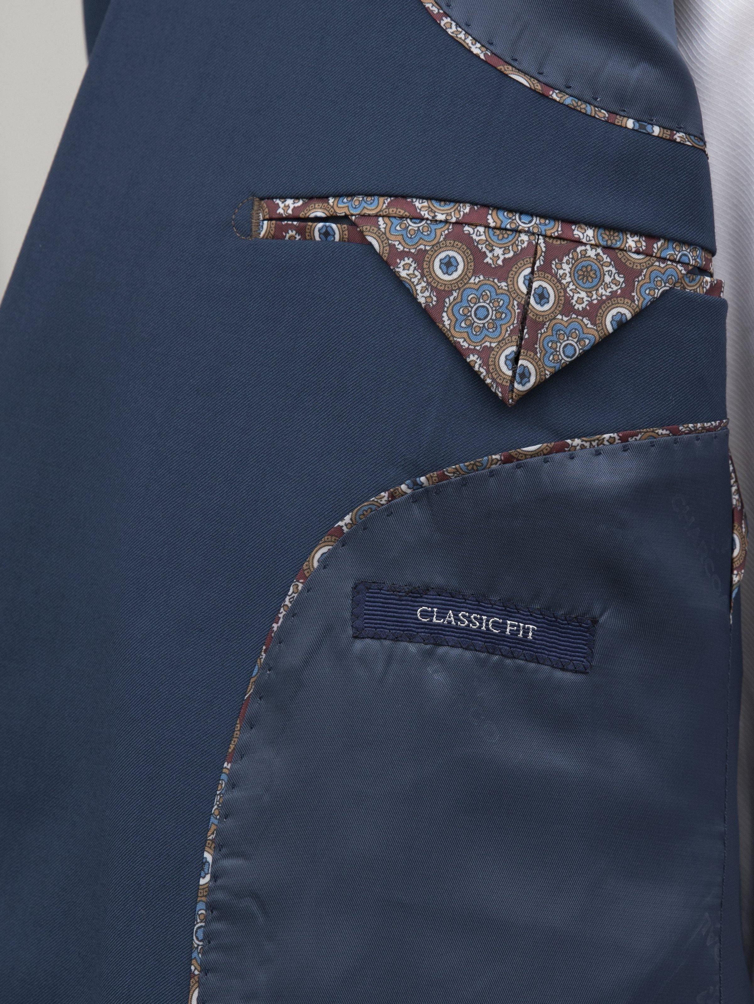 Blue suit jacket inner pocket lining with patterned trim and 'Classic Fit' label