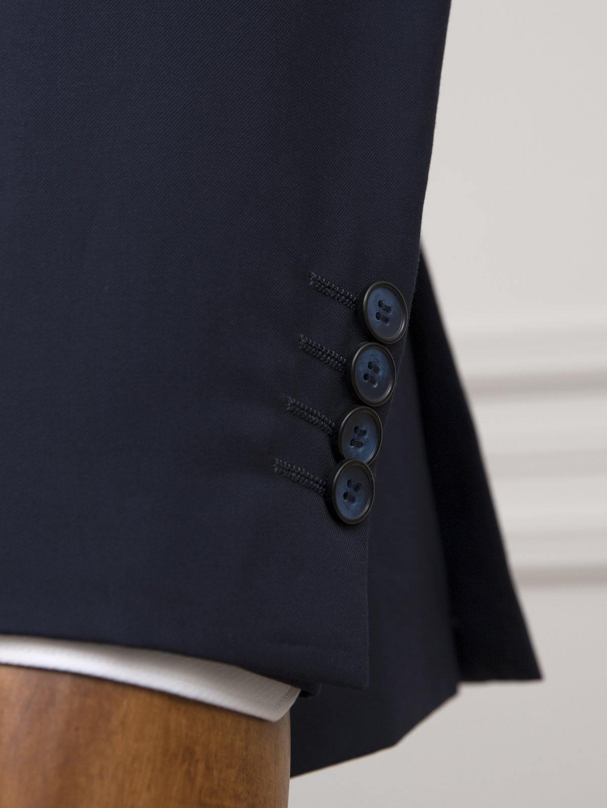 Navy suit jacket sleeve detail with four buttons and inner cuff