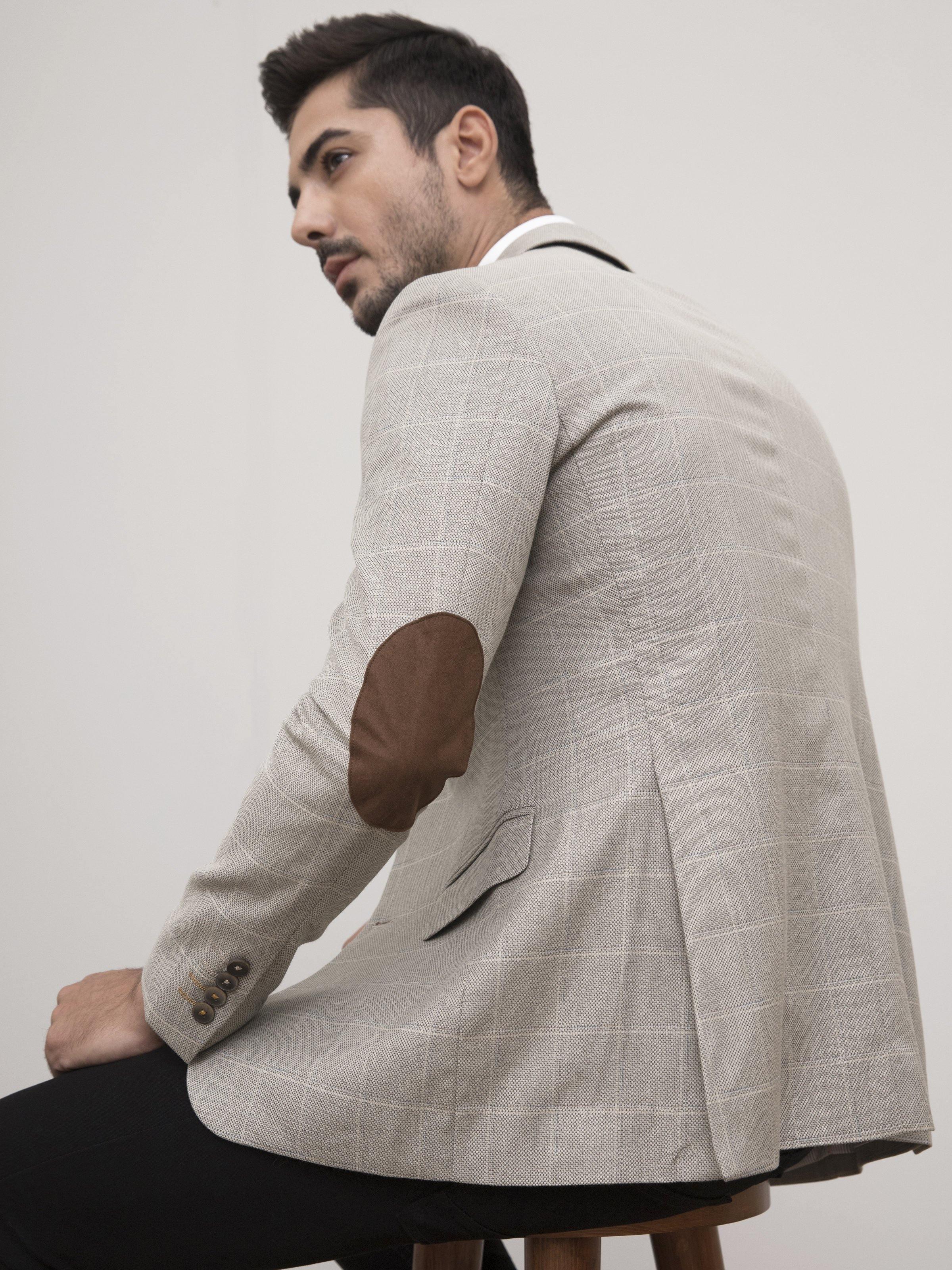 Men's slim-fit tan plaid blazer side view, flap pocket and buttoned cuff