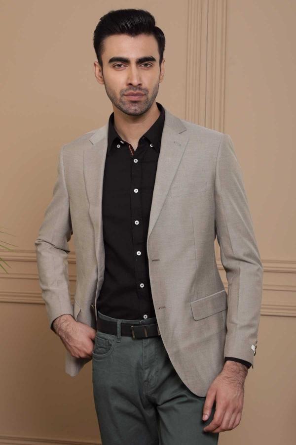 Slim-fit light brown blazer with notch lapel and front pockets, worn over black shirt