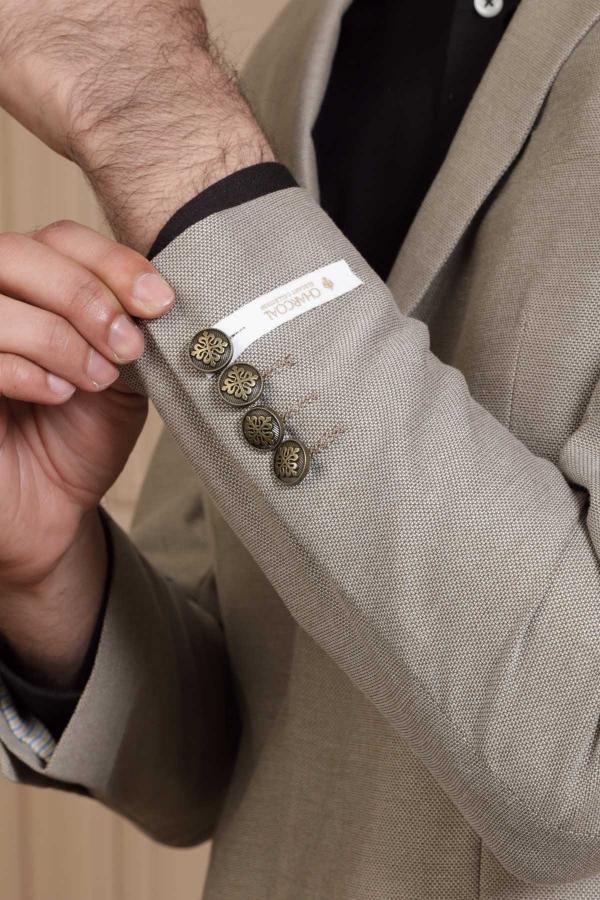 Light brown blazer cuff with button closure and inner lining detail