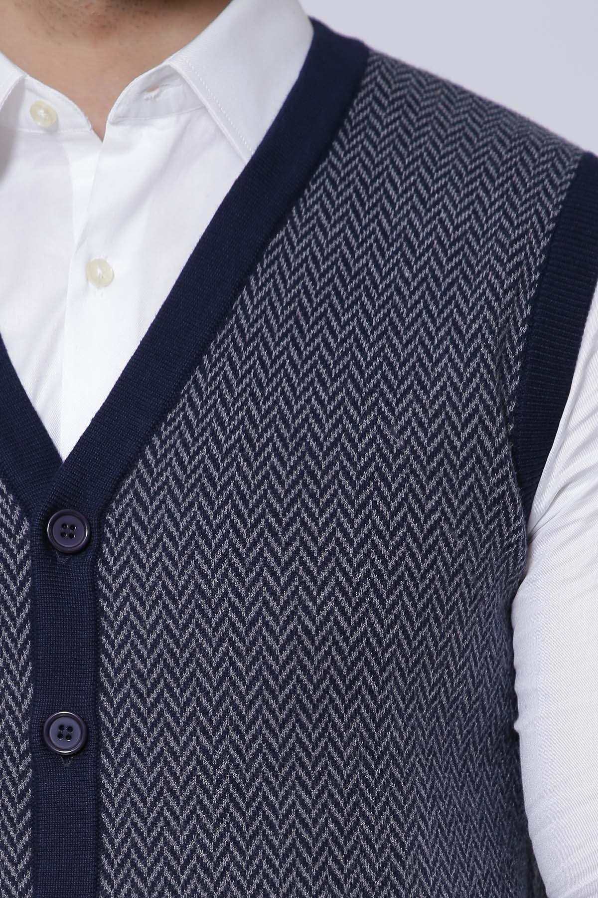 Sleeveless knit cardigan vest close-up, dark button placket and textured navy-gray fabric
