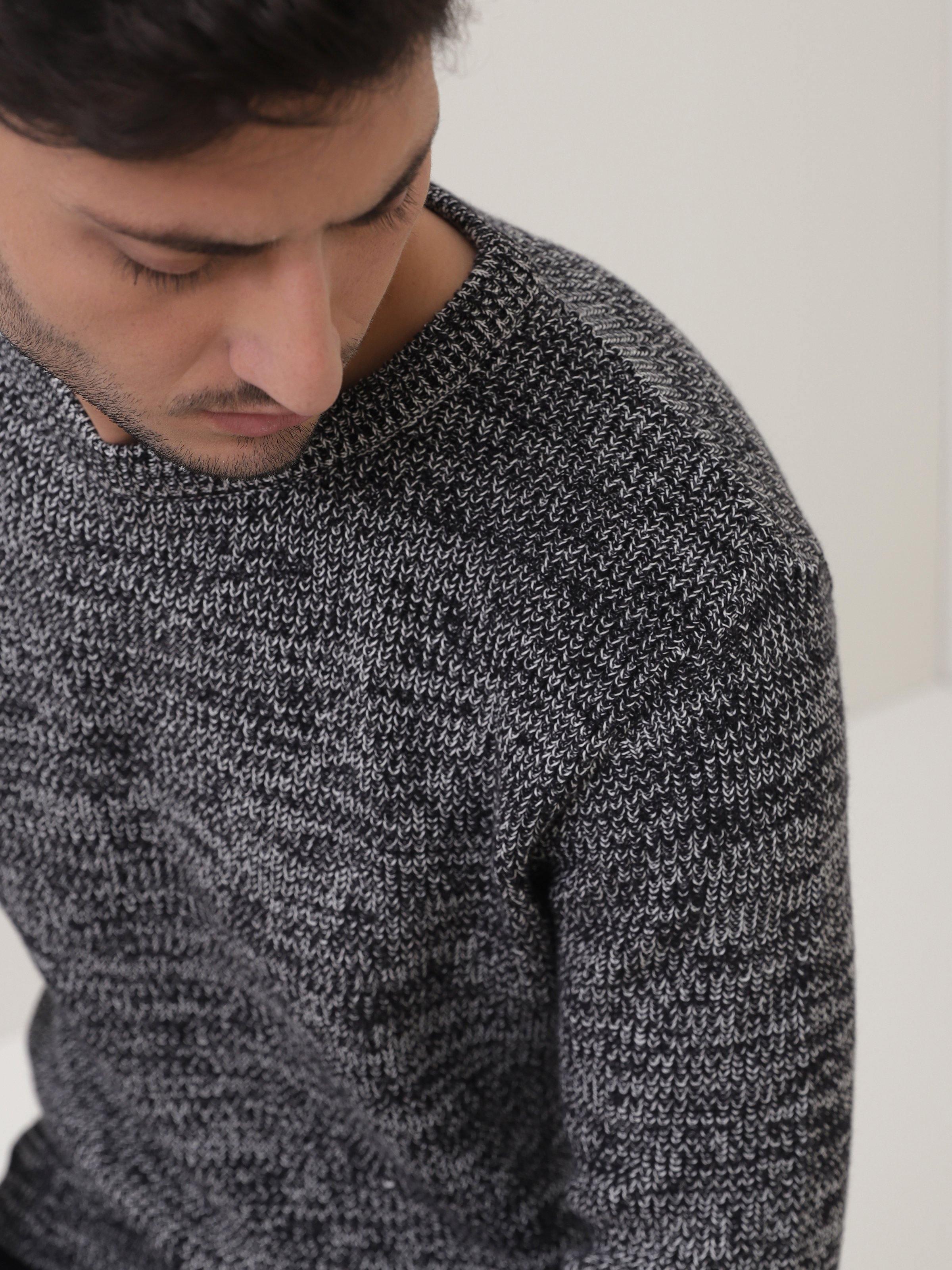 Crew-neck knit sweater close-up in dark heather gray, textured knit detail