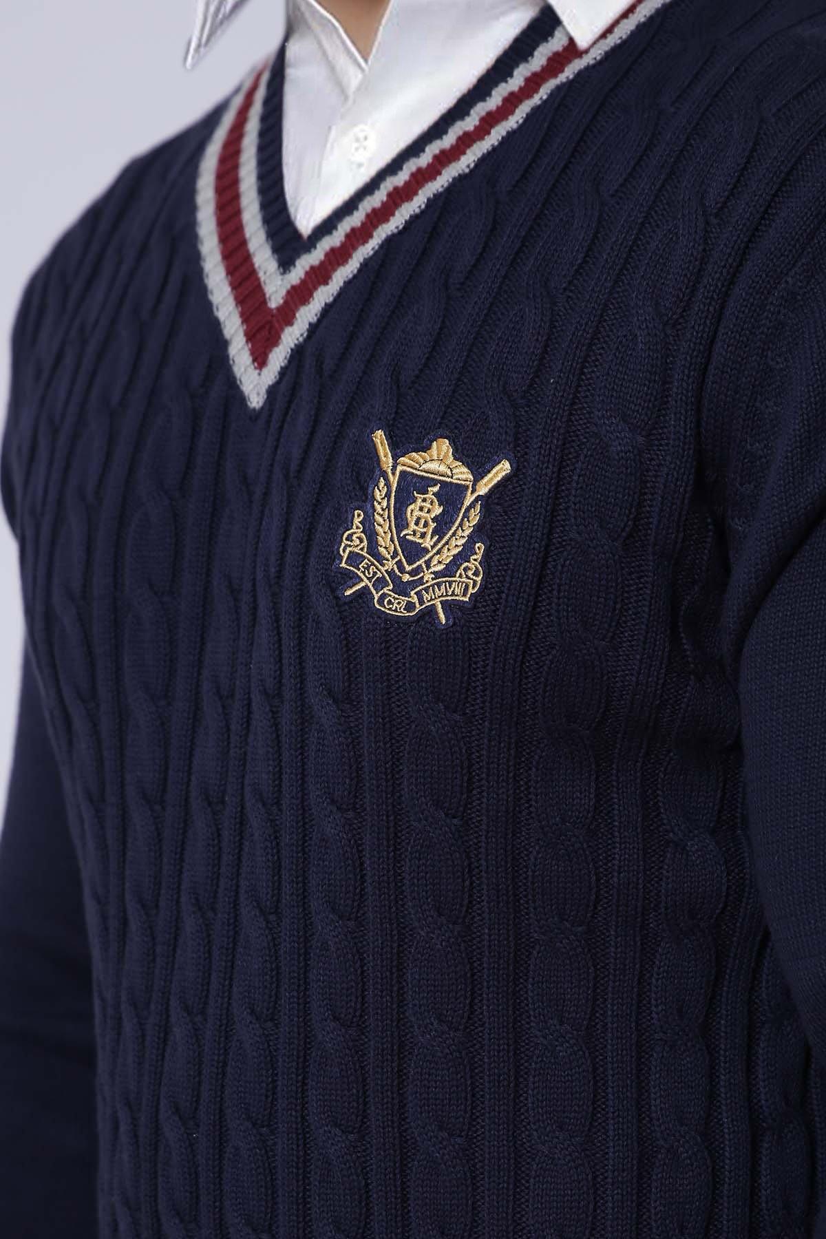 Navy cable-knit V-neck sweater with striped collar and crest logo