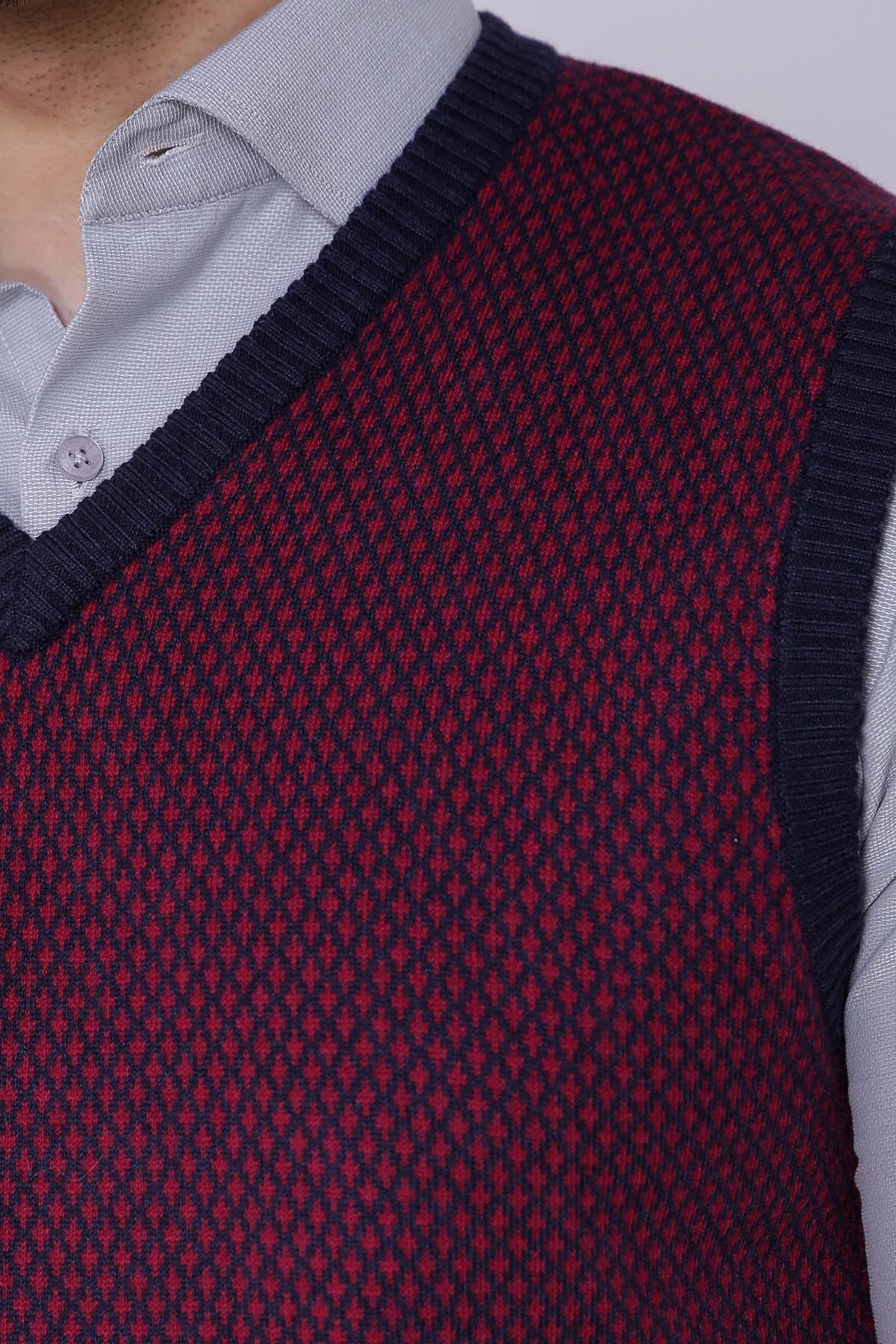 Close-up of maroon knit sweater vest with navy V-neck trim