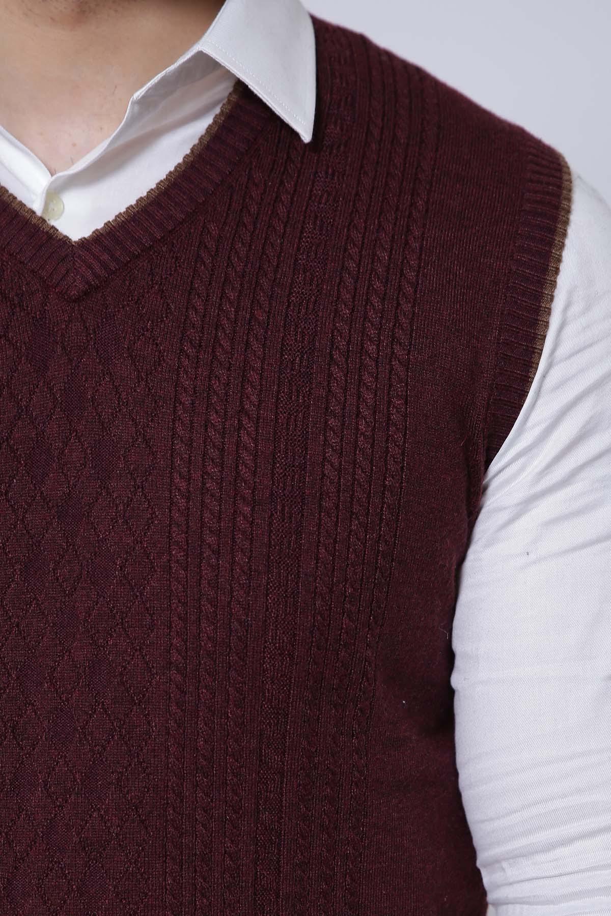 Maroon cable-knit V-neck sweater vest close-up on textured pattern