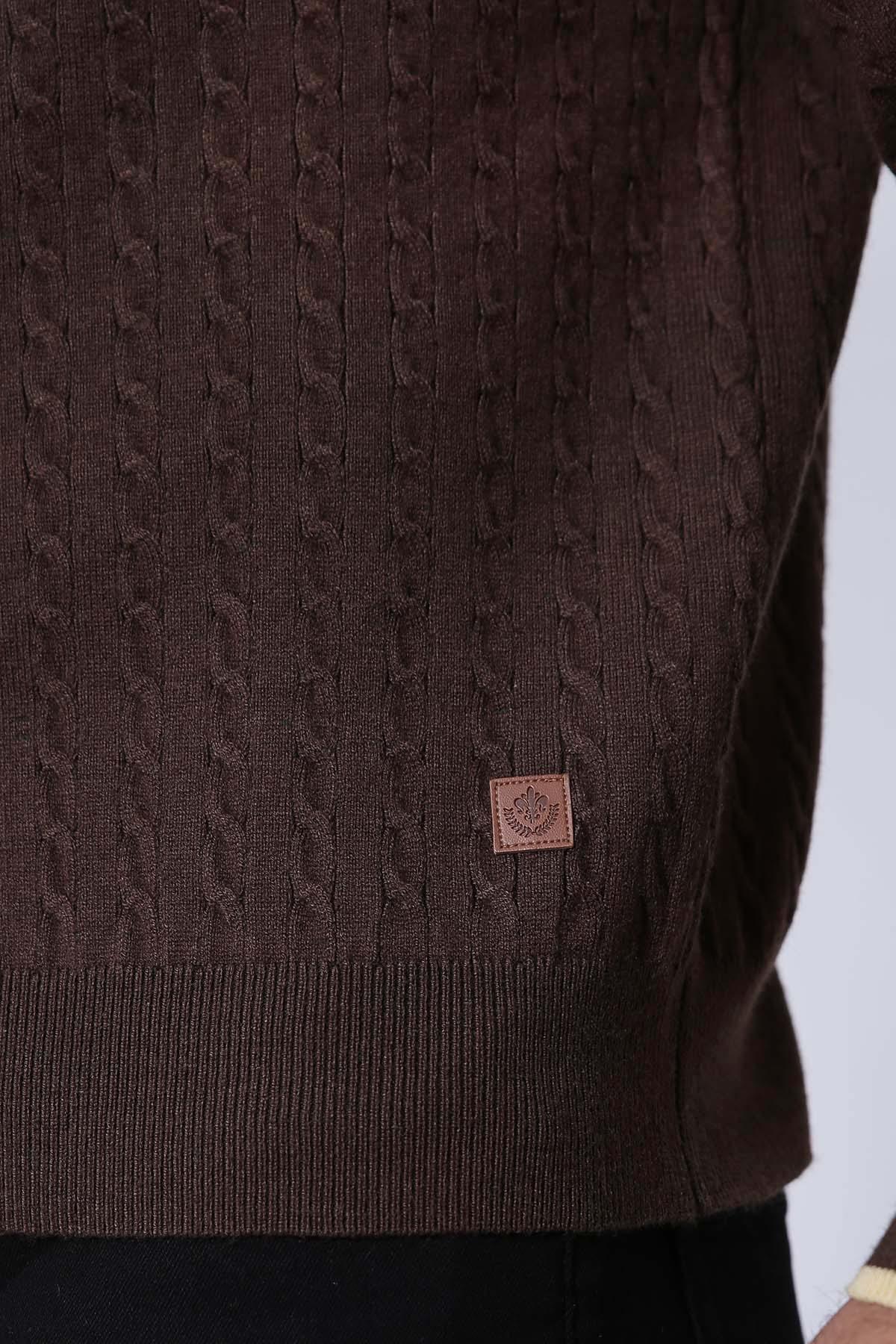 Brown knit zip sweater close-up with logo patch and ribbed hem