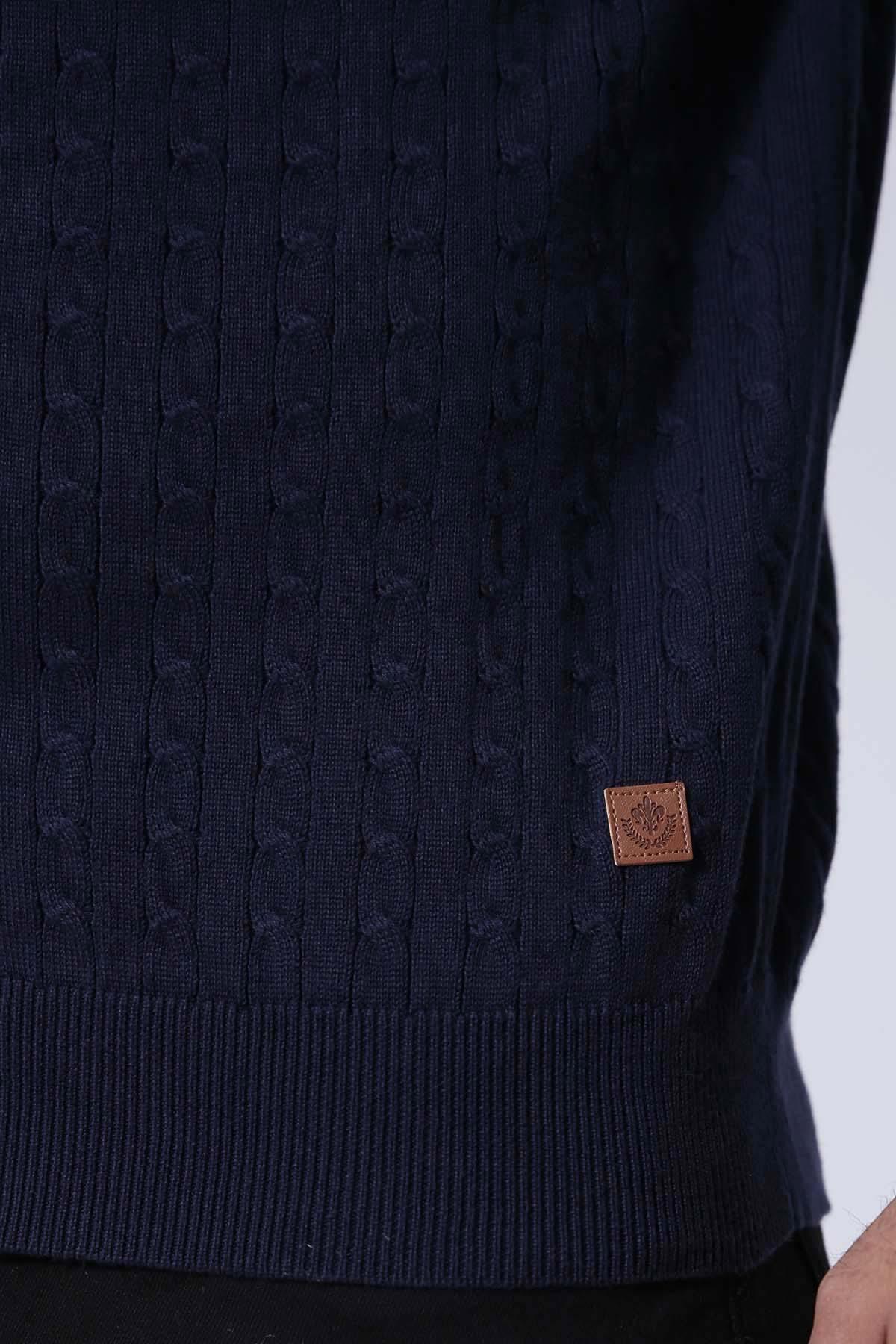 Navy ribbed zip-up sweater detail with leather-look logo patch