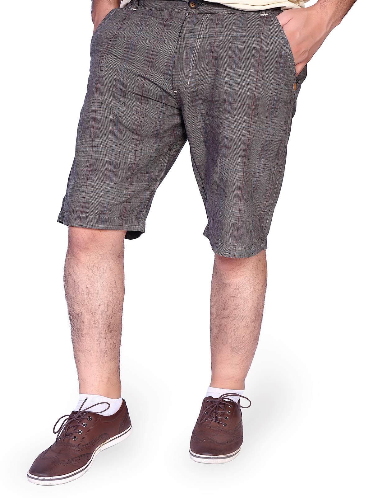 Brown check shorts worn by a model, mid-thigh length with cuffed hem