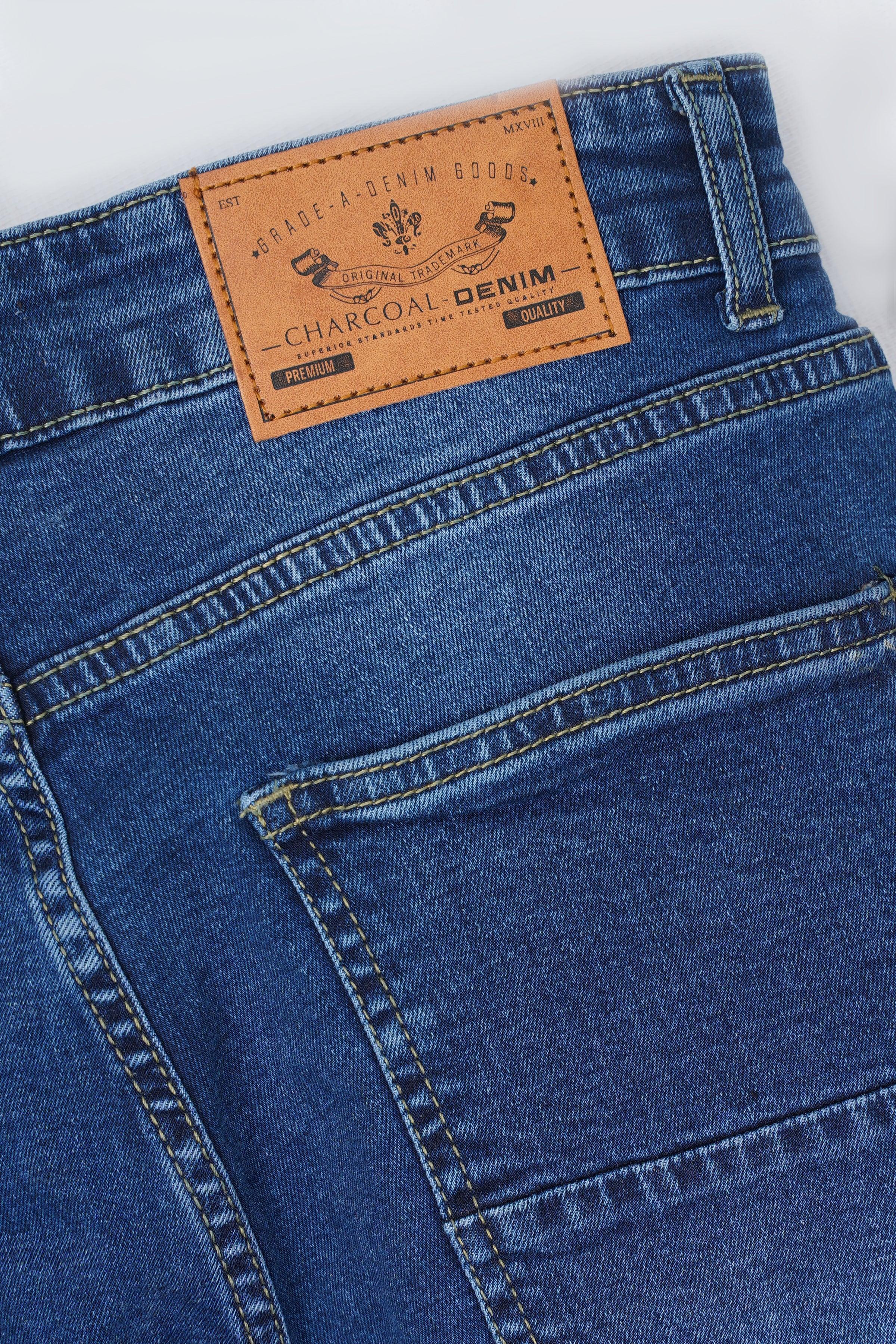 Mid blue skinny jeans with stitched back pocket and leather-look label