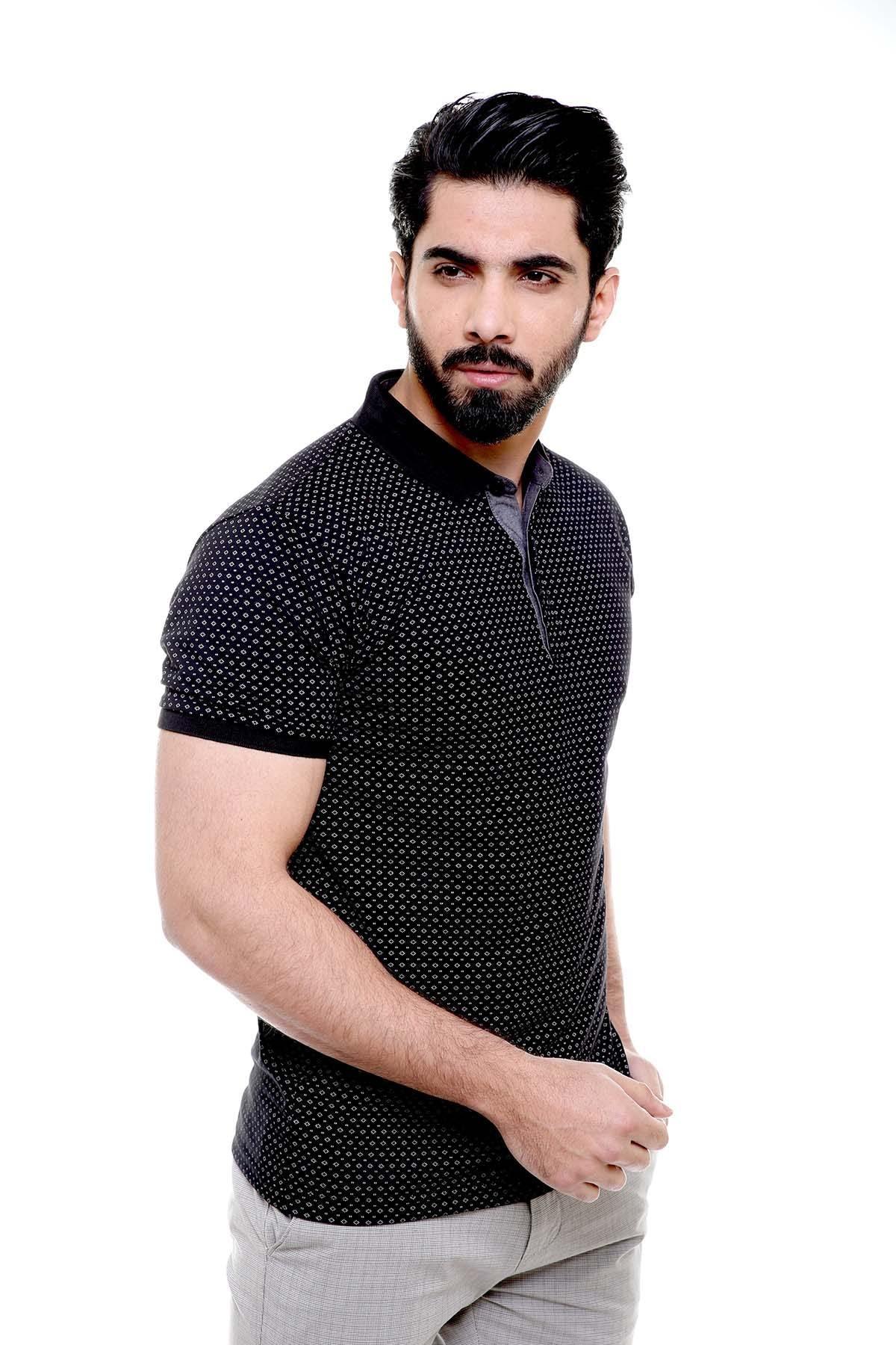 Black polo t-shirt with short sleeves, button placket and patterned knit, close-up.
