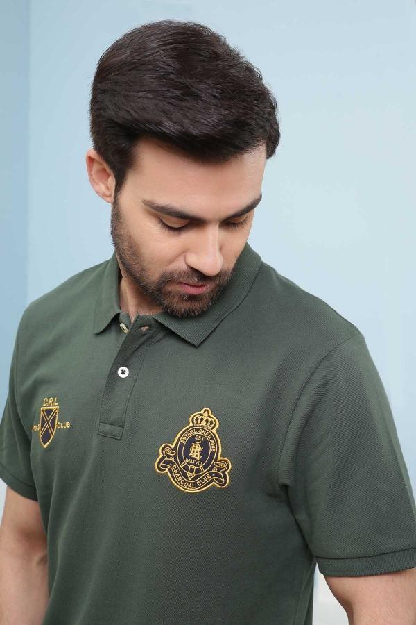 Green polo T-shirt front with collar, short sleeves, and embroidered crest logos