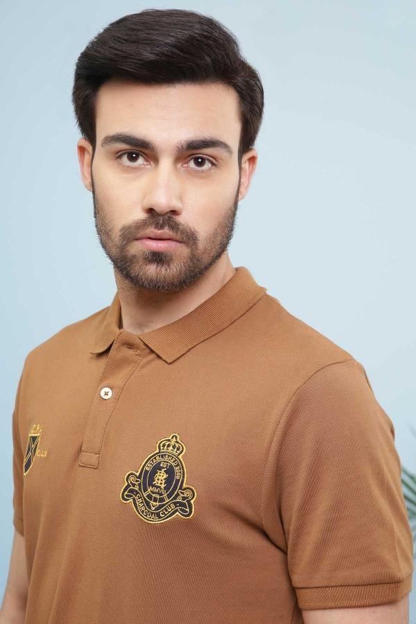 Men's khaki polo shirt close-up: collar, buttons, and embroidered chest crest