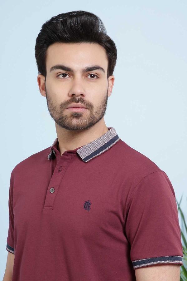 Maroon polo T-shirt close-up with striped collar and small chest logo