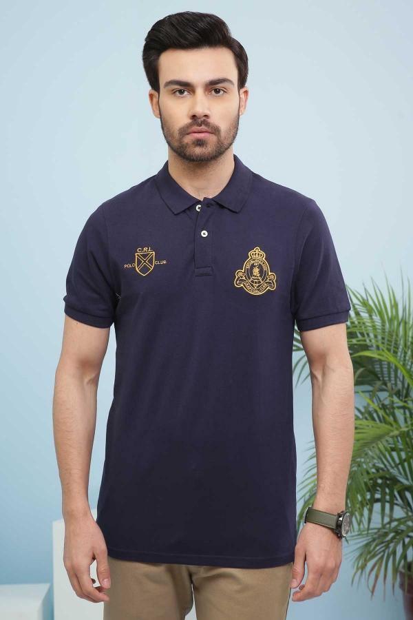 Navy polo shirt with button placket and small chest crest patches
