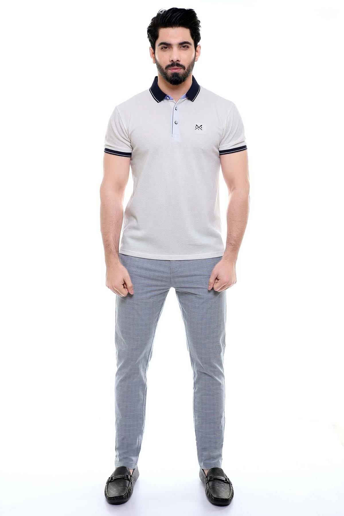 Off-white polo shirt with navy collar, short sleeves, small chest logo