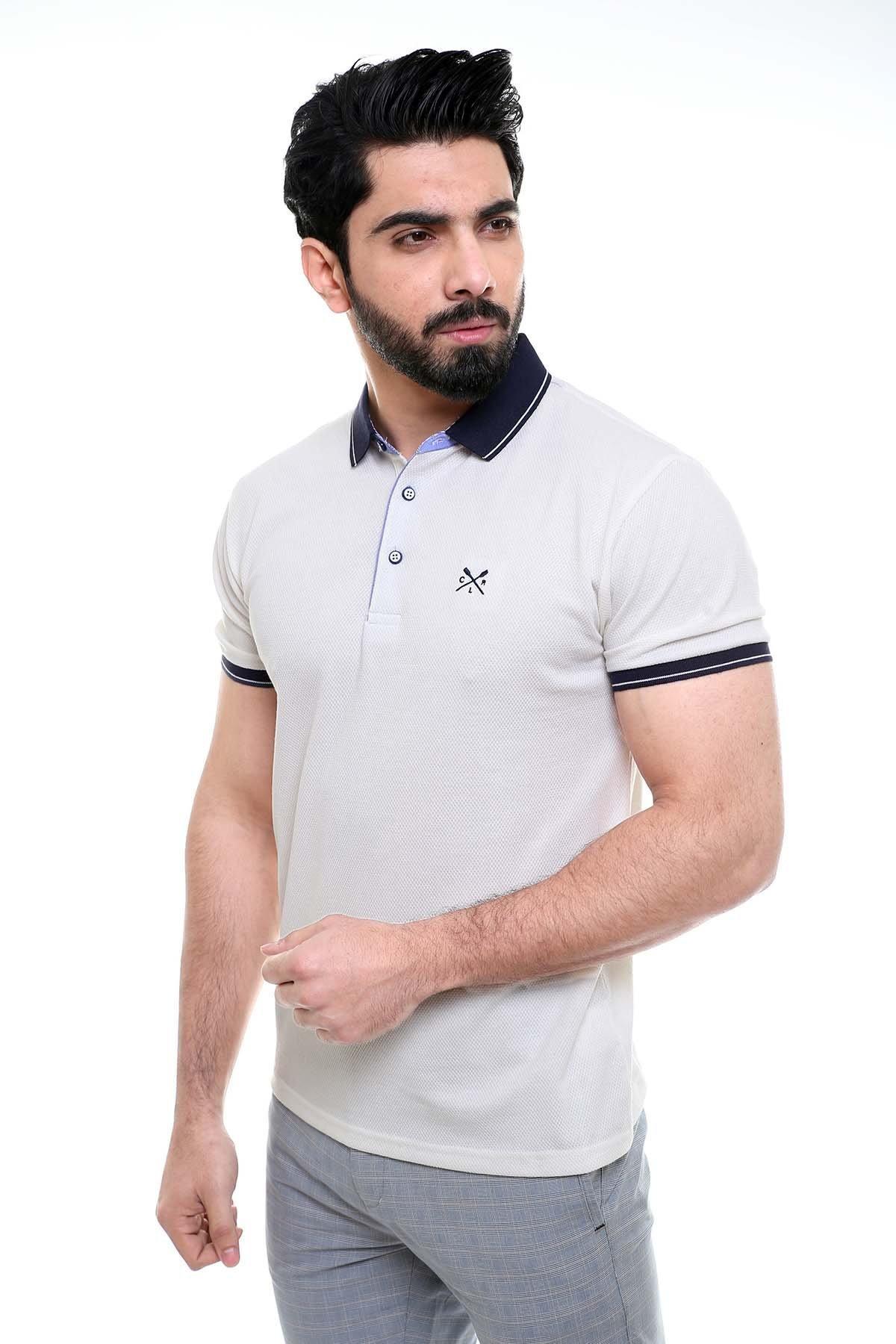 Off-white polo shirt with navy collar and sleeve trim, button placket