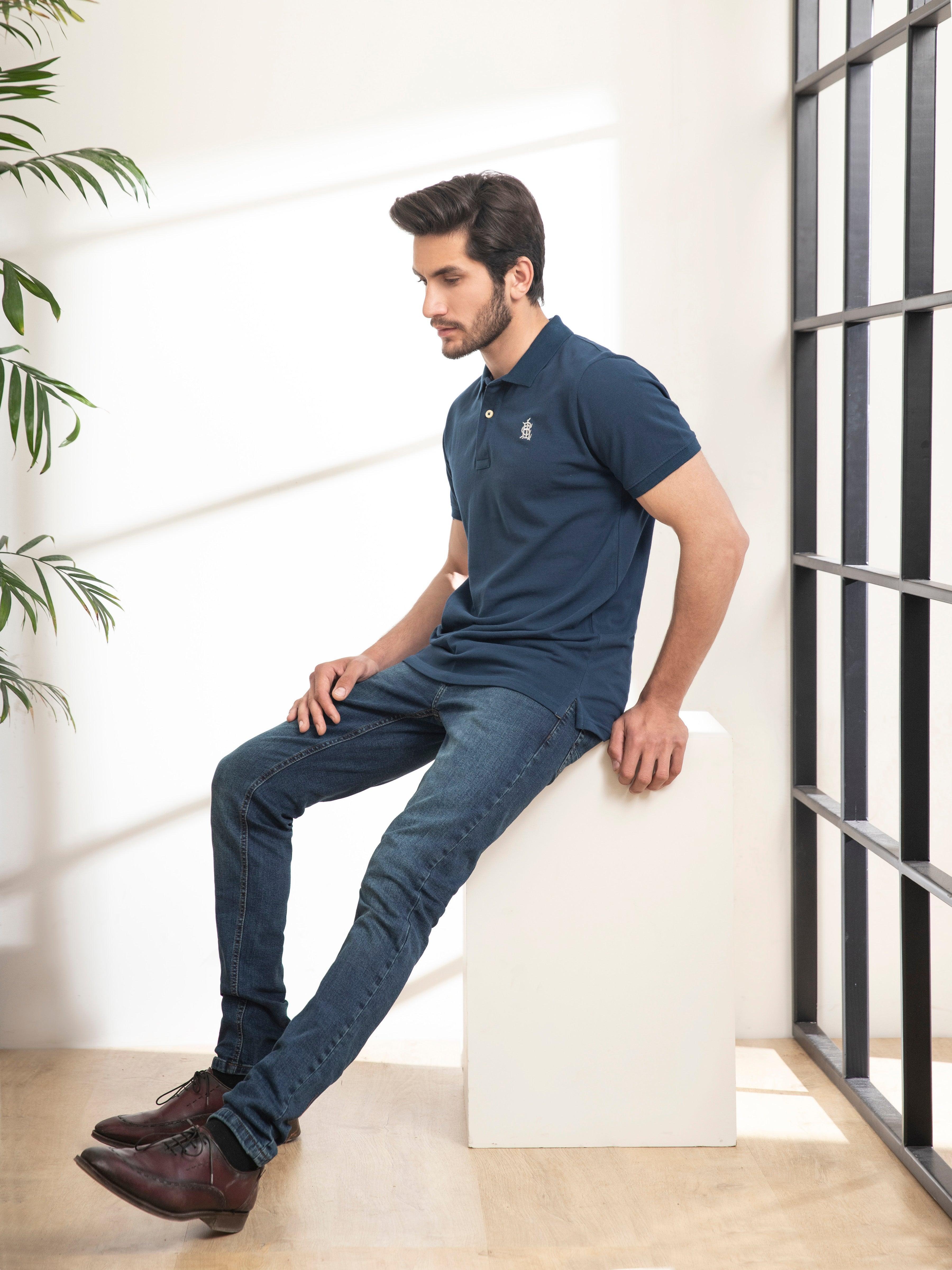 Teal polo T-shirt with short sleeves and button placket, side view