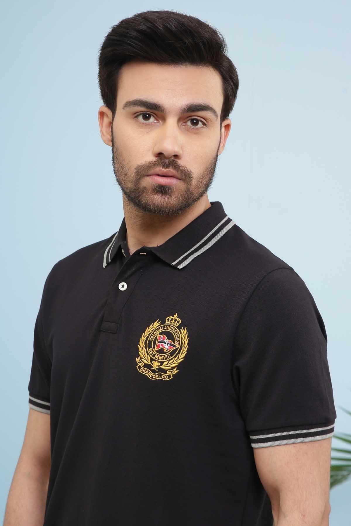 Black polo shirt with button placket, white striped collar, crest logo on chest