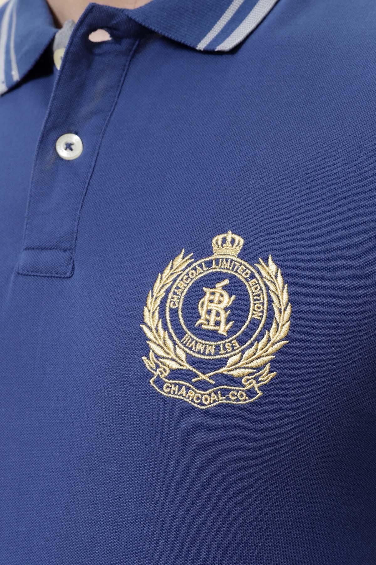 Royal blue polo shirt close-up, striped tipped collar and chest emblem logo