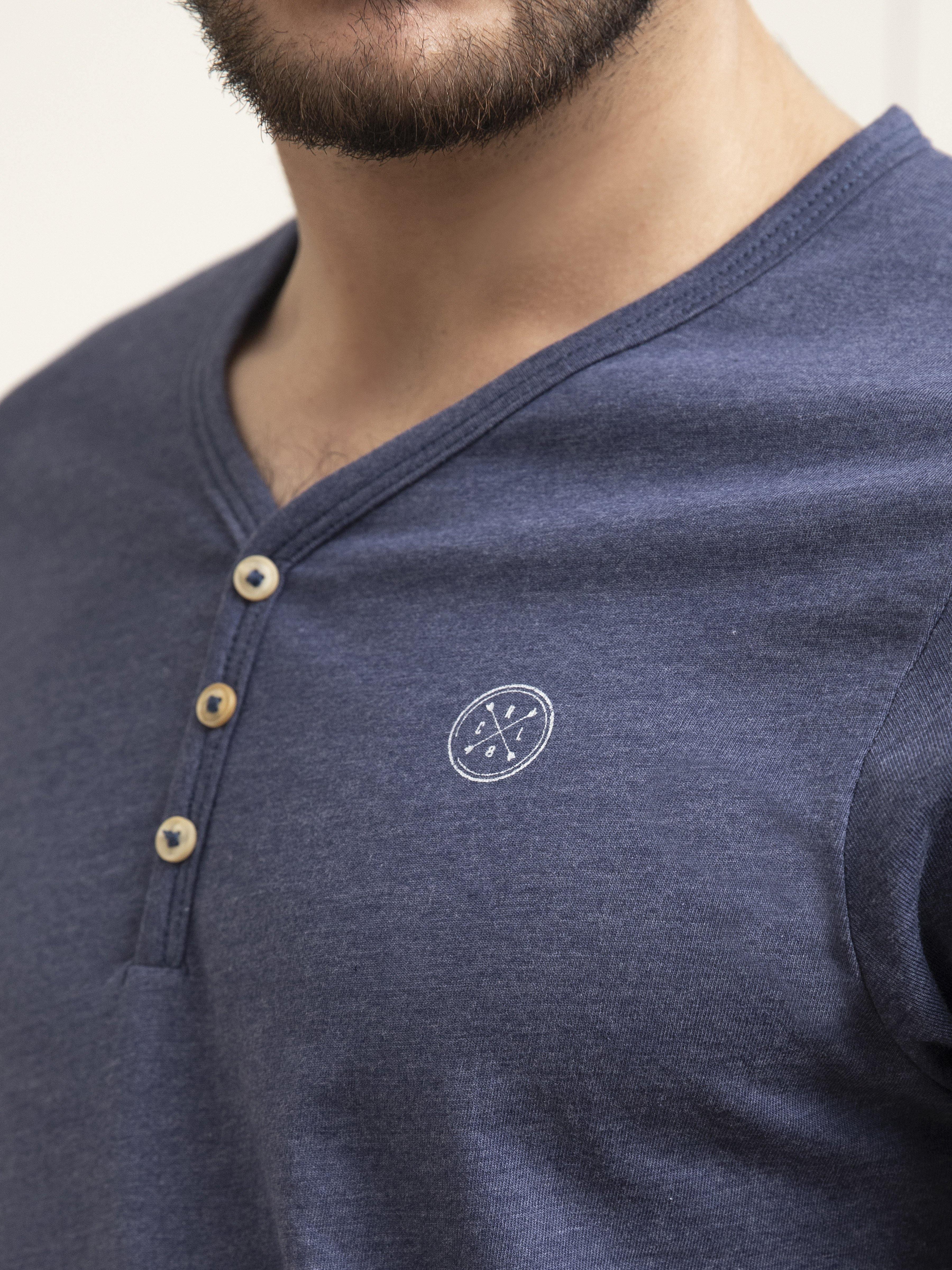 Men's dark blue V-neck T-shirt detail: button placket and small chest logo